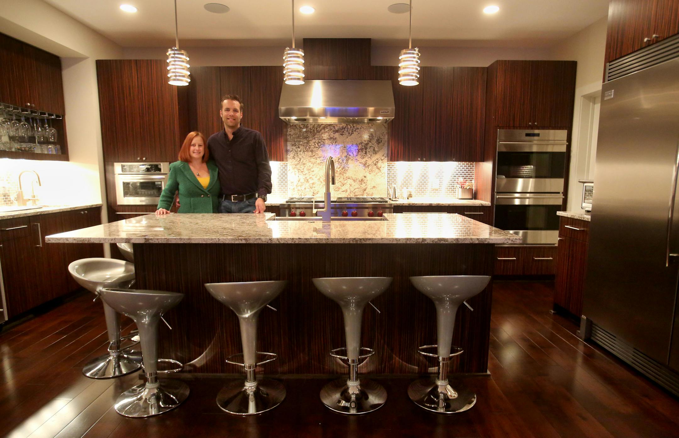 Judy Engel and Peter Schulzetenberg in their dream kitchen. Schulzetenberg designed and built the Italian ebony cabinets, along with the bathroom cabinets and much of their furniture.