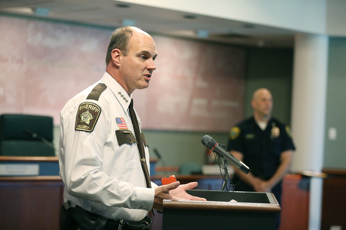 Hennepin County Sheriff Rich Stanek and Brooklyn Park Police Chief Craig Enevoldsen showed a video of a 25-year-old man who was "locked in a violent struggle for three minutes with a Brooklyn Park police officer, during which the man kept trying to grab the officer's holstered gun, during a press conference at the Brooklyn Park City Hall, Thursday, May 19, 2016 in Brooklyn Park, MN. ] (ELIZABETH FLORES/STAR TRIBUNE) ELIZABETH FLORES &#x2022; eflores@startribune.com