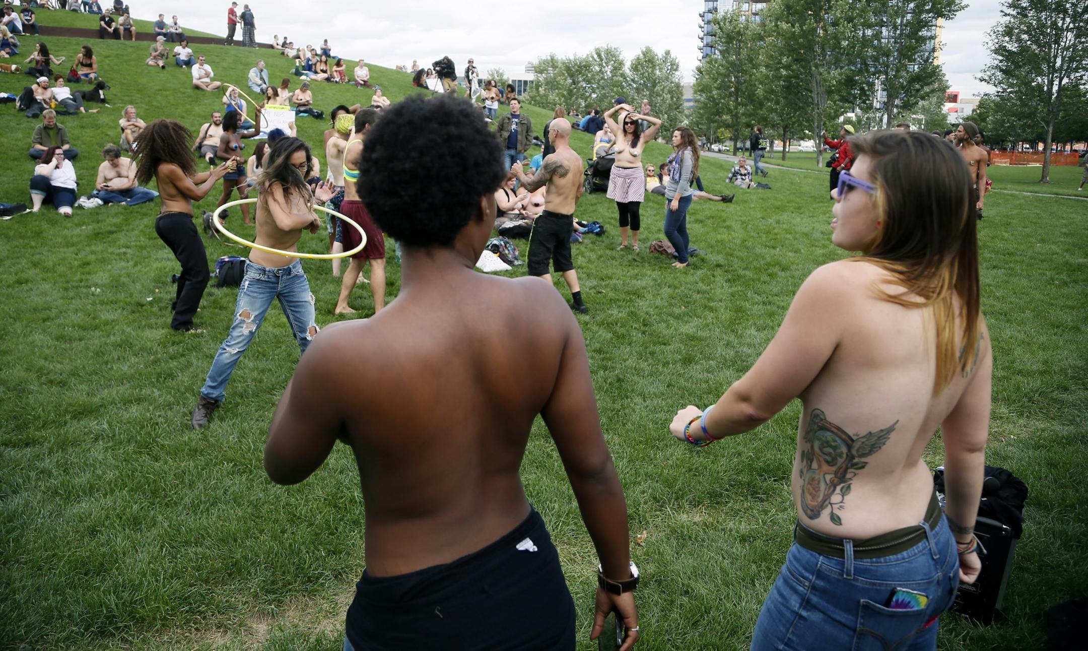 Saying it's a matter of gender equity and freedom of expression, topless demonstrators danced at Gold Medal Park Sunday August 23, 2015 in Minneapolis, MN.