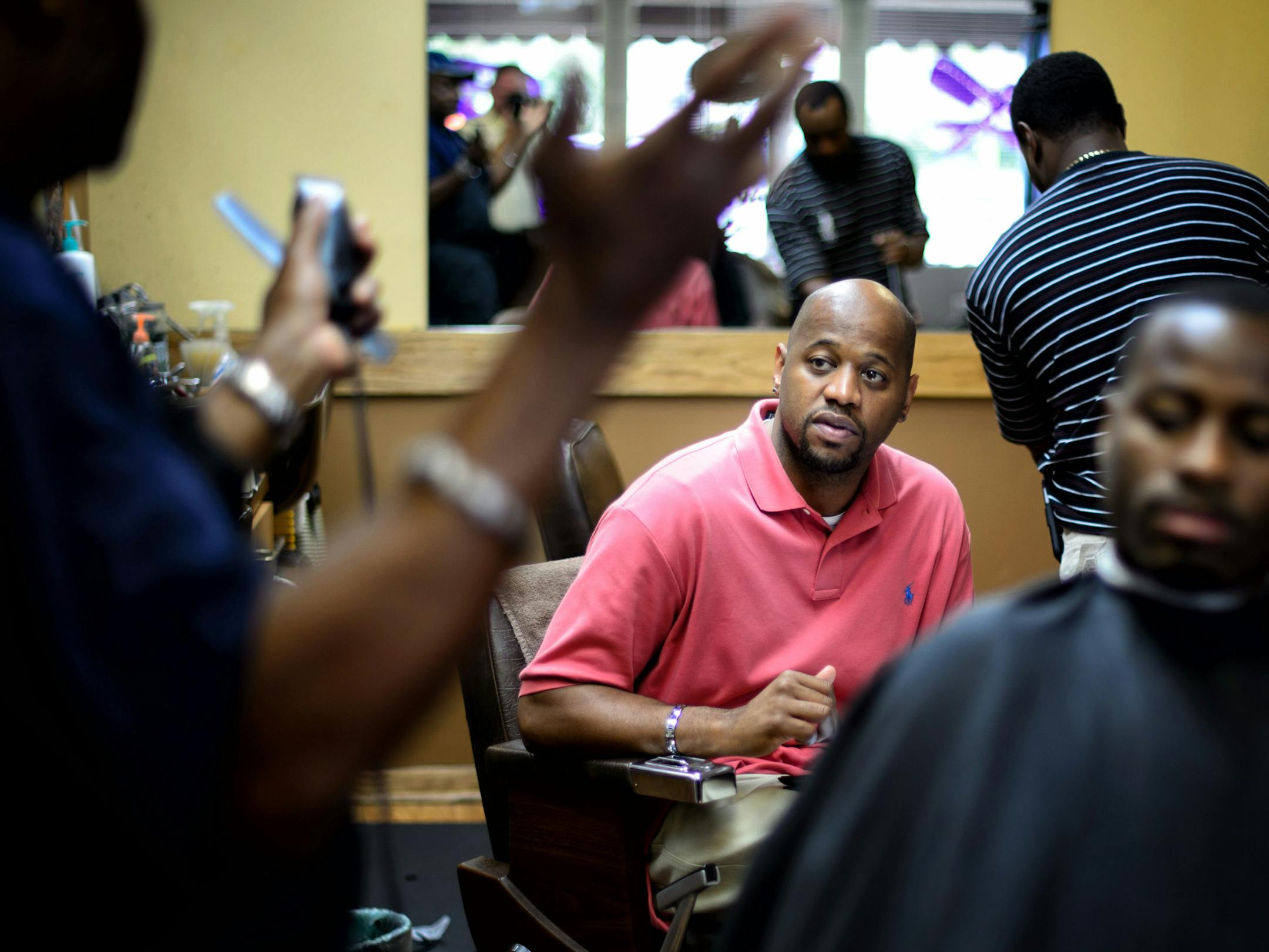 Michael Walker, new director of the Office of Black Male Achievement talked with customer Jonathan Brown and owner Kevin Jones at All Hair Cuts & Styling in South Minneapolis. Walker is on a listening tour starting with barbershops. He asked questions, listened a lot and took detailed notes. ] Minneapolis , MN -- Friday, August 22, 2014. GLEN STUBBE * gstubbe@startribune.com