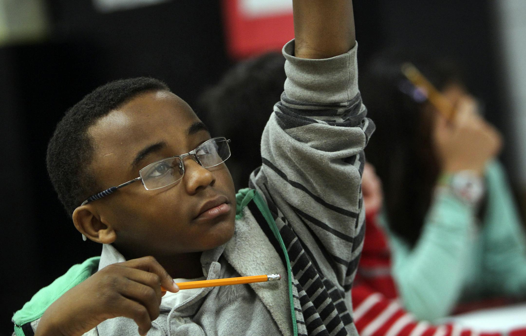 February, 2013: Fifth grader Jeremiah Jones at Sky Oaks Elementary School in Burnsville raises his hand to answer a question during math class on an in-class assignment using iPads and an app called Socrative to test students and get immediate feedback on how they are doing.