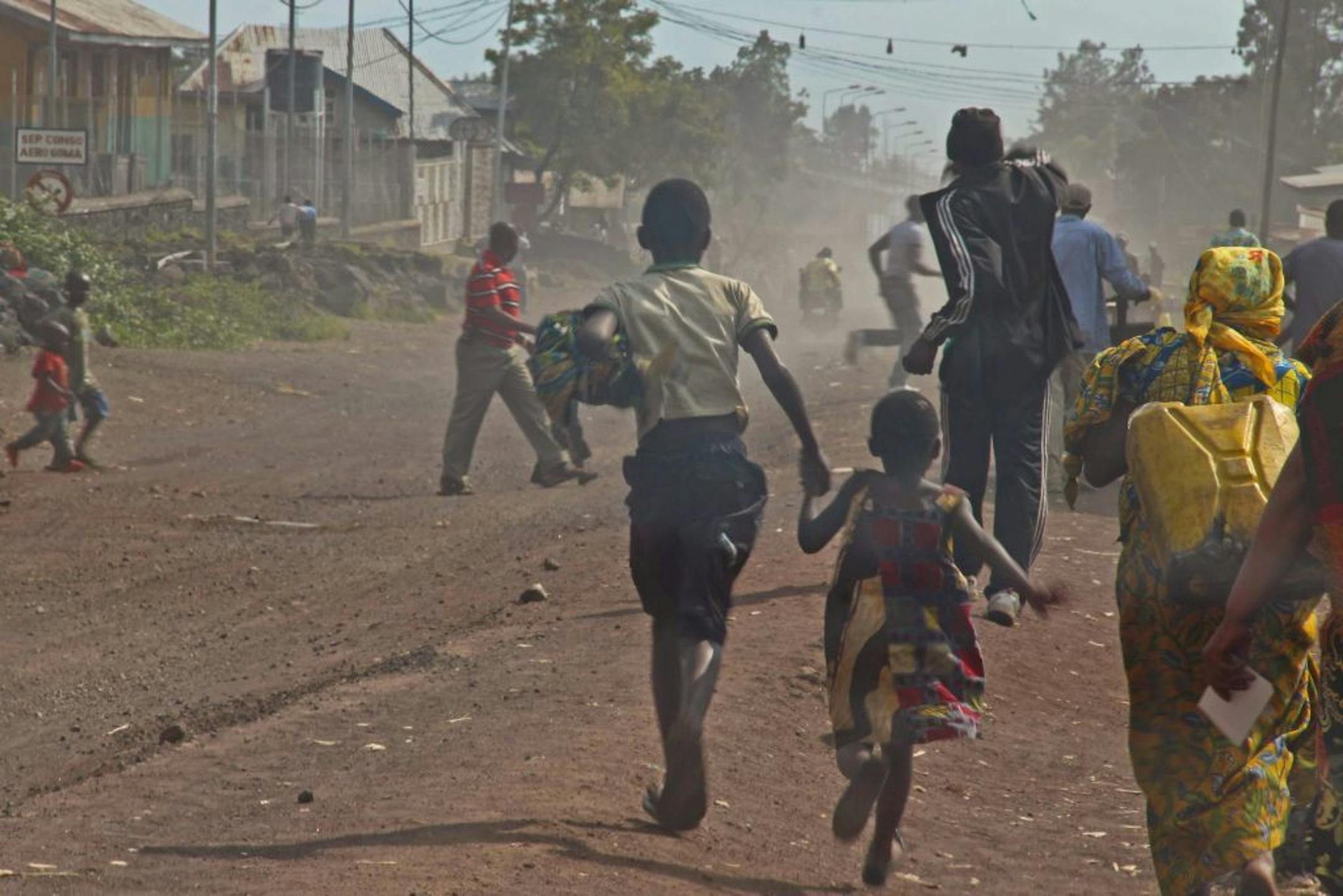 People flee as fighting erupts between the M23 rebels and Congolese army near the airport at Goma, Congo, Monday, Nov. 19, 2012.