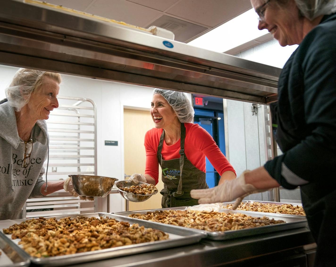 Owner Tasya Kelen, center, helped out employees Missy Walk and Jeremie Mercer as the produced a batch of Zesty Lemon Rosemary blend. Isadore Nut Co. works out of The kitchen of Cornerstone Creek, an apartment for people with disabilities. ] GLEN STUBBE &#xef; glen.stubbe@startribune.com Wednesday, December 12, 2018 The newest resident at Cornerstone Creek, an apartment building for people with disabilities, is a local nut roaster that has taken up home in the commercial kitchen that provides mea