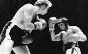 Scott Ledoux and Muhammad Ali in a five-round exhibition fight 12-04-77. UPI photo. ORG XMIT: MIN2016060323195417