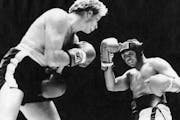 Scott Ledoux and Muhammad Ali in a five-round exhibition fight 12-04-77. UPI photo. ORG XMIT: MIN2016060323195417