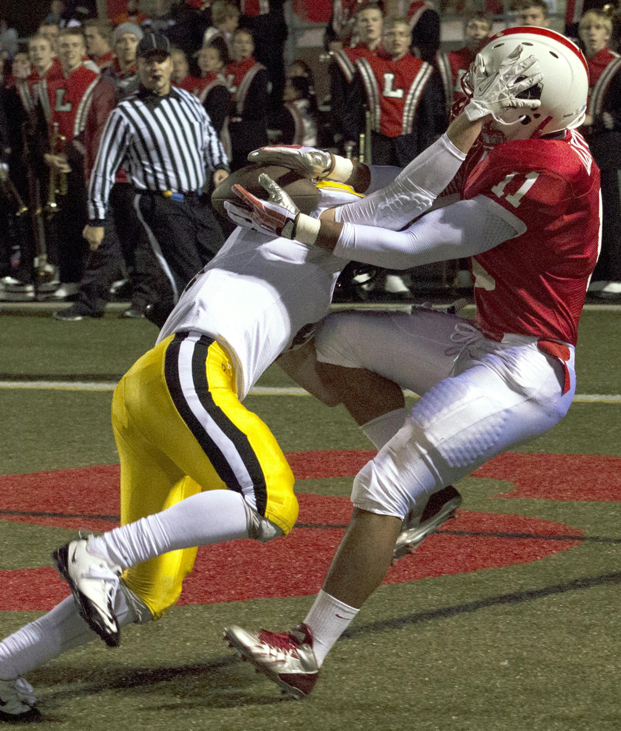 Lakeville North High School's Gregory Menard makes a touchdown reception during the first quarter of Friday night's game against Burnsville High School. ] (Matthew Hintz, 100413, Lakeville)