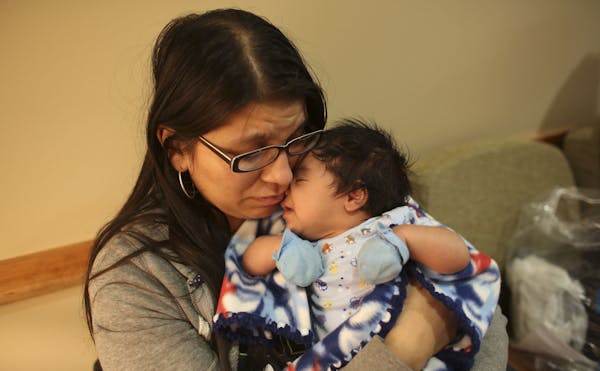 Christina Alonzo held her son Elijah, two months, in the lobby of the Maple Grove Hospital in Maple Grove Min., Tuesday, June 18, 2013. Alonzo was fin