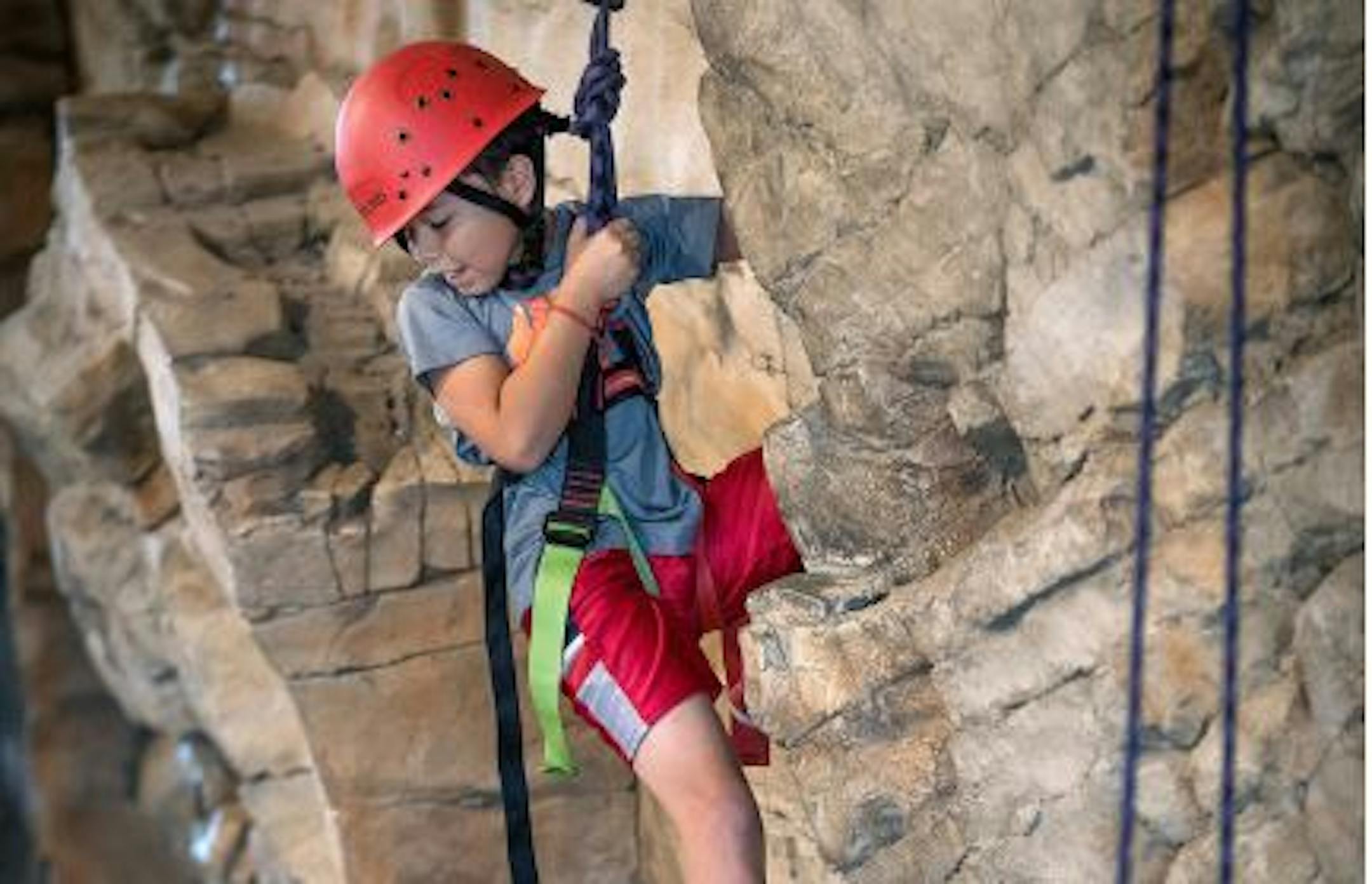 A student from Sand Creek Elementary in Coon Rapids took a turn on the rock-climbing wall at the Northern Star Scouts Base Camp at Fort Snelling. It celebrates its completion with an open house Saturday.