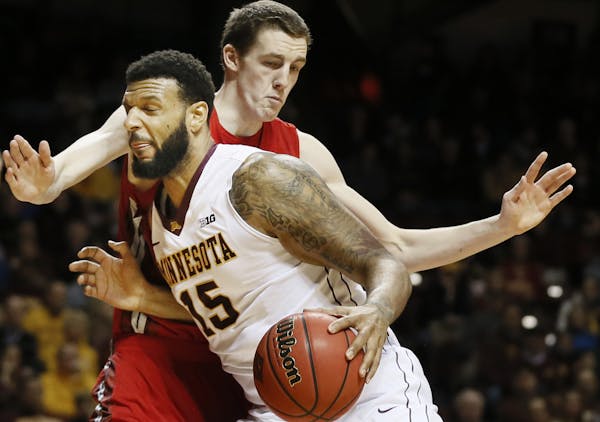 Maurice Walker (15) drove to the basket on Western Kentucky forward Ben Lawson (14) at Williams Arena in November.