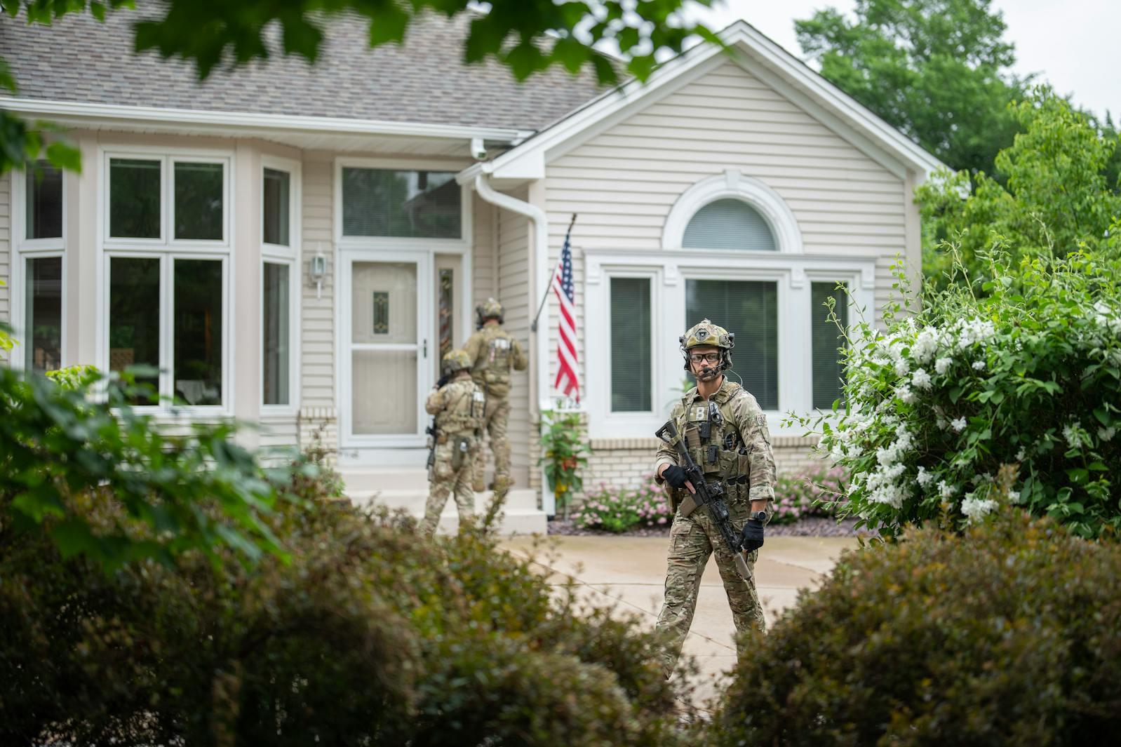 Armed FBI agents search for an active shooter by sweeping a neighborhood adjacent to the home of Minnesota DFL State Representative Melissa Hortman in Brooklyn Park Saturday.