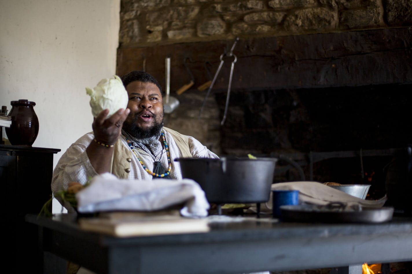 Michael Twitty tells the crowd how he will encase the chicken in cabbage leaves before putting it over the coals. ] ALEX KORMANN &#x2022; alex.kormann@startribune.com Michael Twitty, a historian, chef and author spent the day at Fort Snelling in a kitchen once actually worked by slaves. He prepared traditional African meals that slaves often cooked for their masters in the 18th and 19th centuries in America. He spoke about the importance and traditions regarding food as well as the history behin