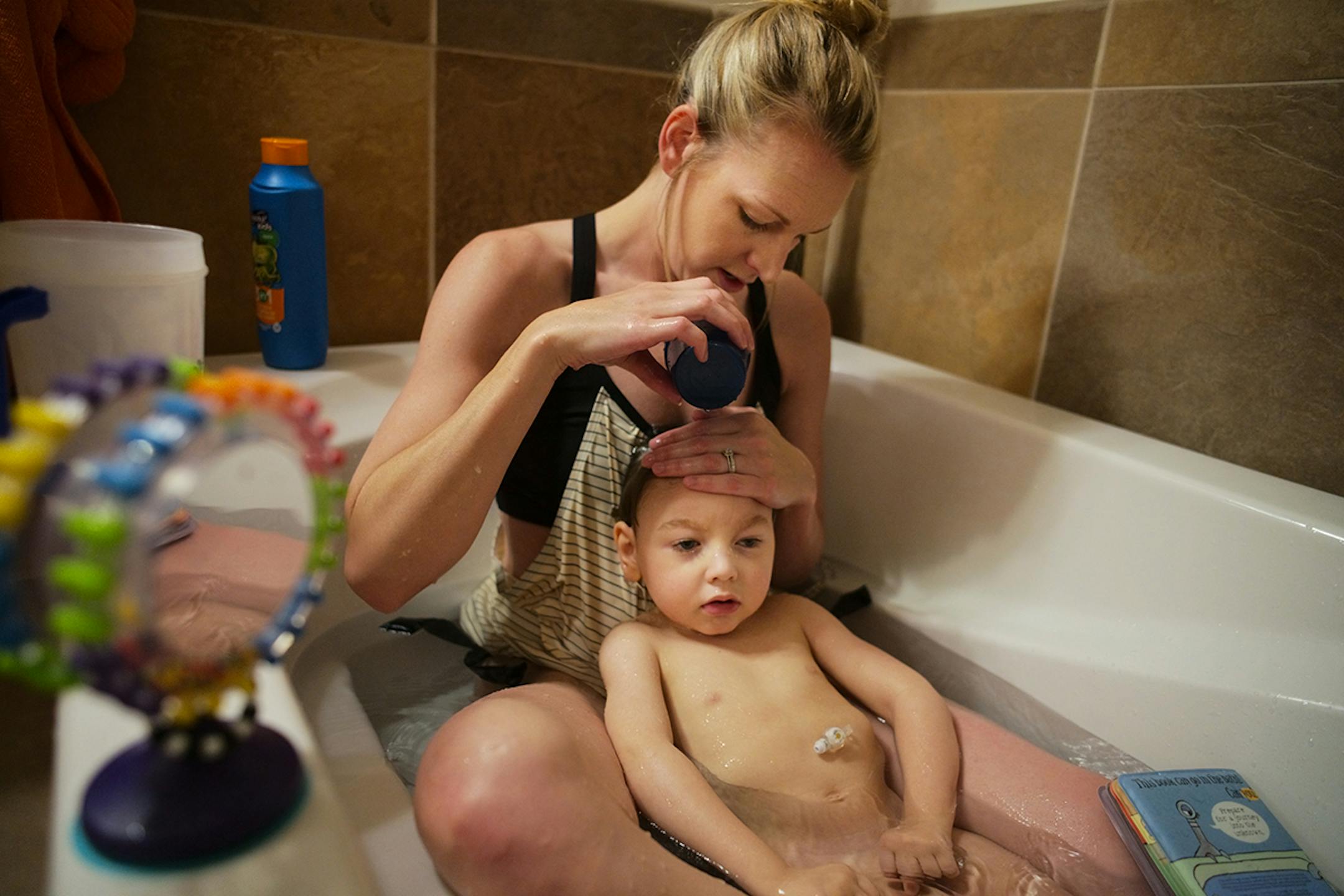 Tiffany Goodchild bathed her son Karter at their home on Friday, July 5, 2019 in Coon Rapids, Minnesota. Goodchild, who once ran a school for special needs children, has dedicated her life to her son by fighting for the highest Medicaid waiver possible to meet his needs.