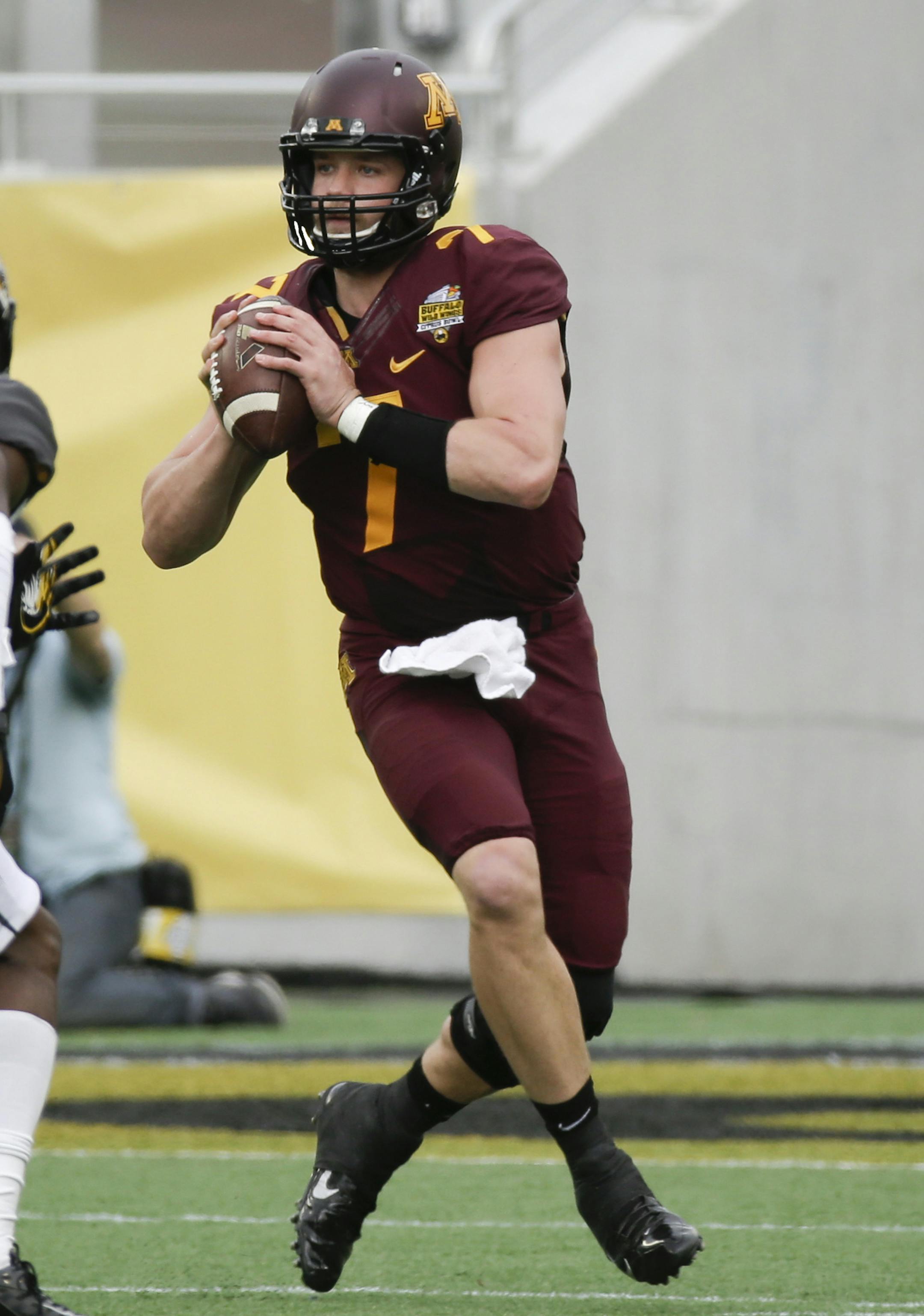 Minnesota quarterback Mitch Leidner (7) looks to throw a pass over Missouri defensive back John Gibson (1) during the first half of the Citrus Bowl NCAA college football game in Orlando, Fla., Thursday, Jan. 1, 2015. (AP Photo/John Raoux) ORG XMIT: otk