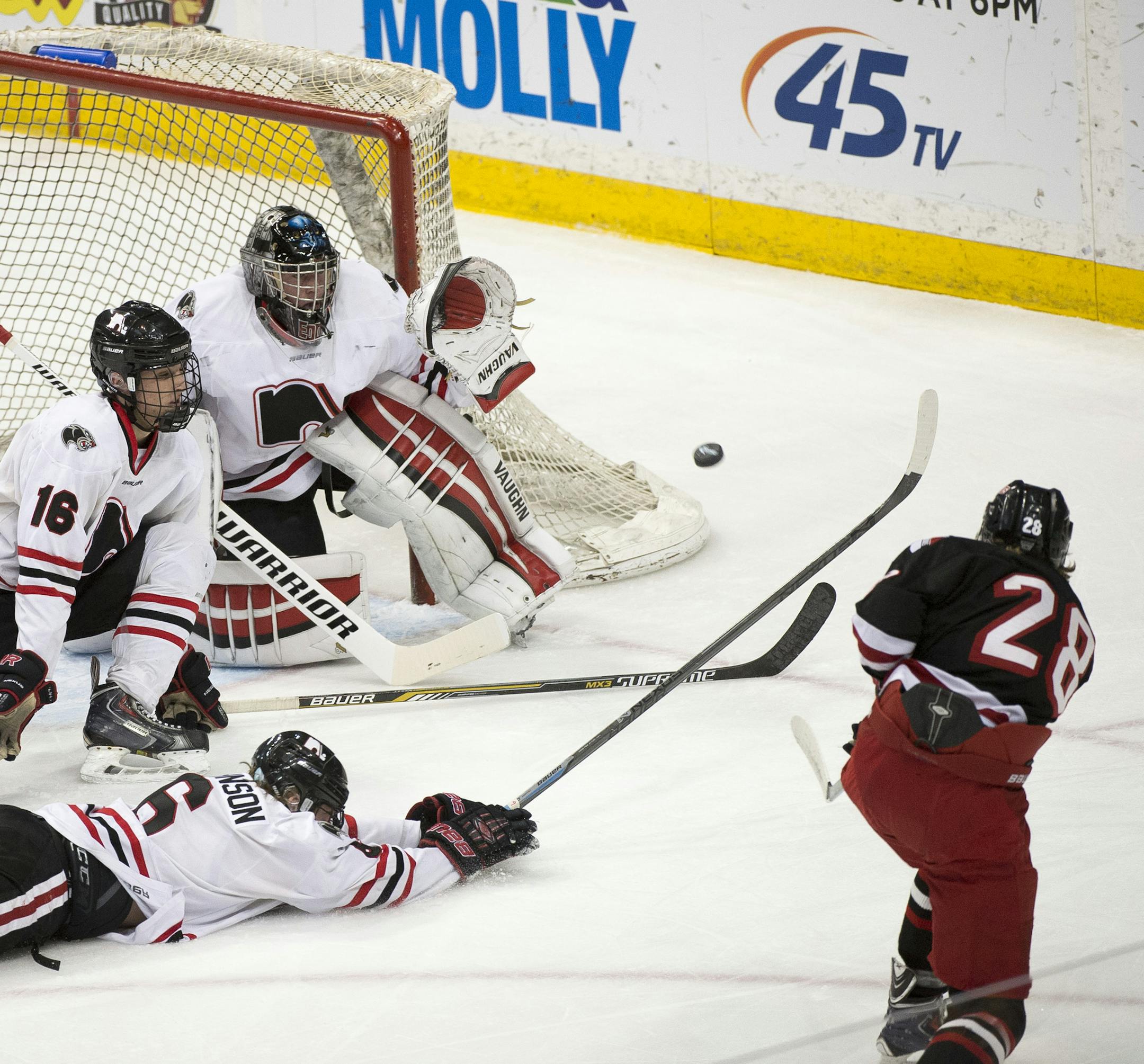 Duluth East defender Shay Donovan (28) takes a shot on Lakeville North's goal in the first period. ] (Aaron Lavinsky | StarTribune) Duluth East plays Lakeville North in the Class 2A boys' hockey championship game on Saturday, March 7, 2015 at Xcel Energy Center.