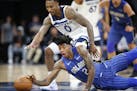 Minnesota Timberwolves guard Jeff Teague (0) and Orlando Magic guard Elfrid Payton (2) chase a loose ball during the second half.