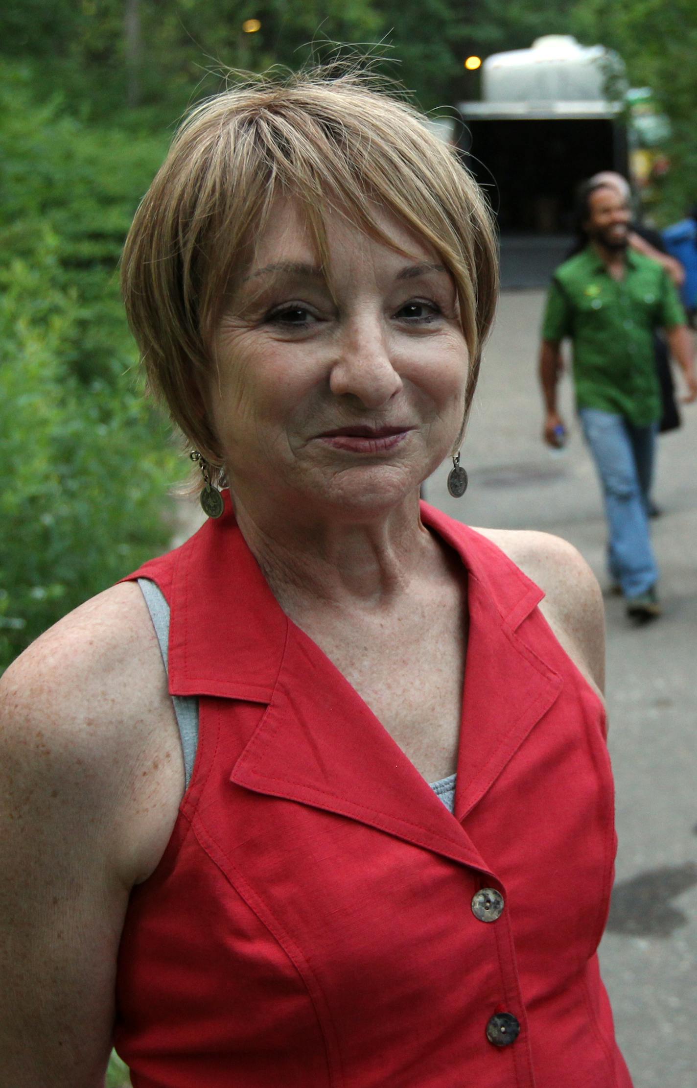 Sue at the July 3rd Ziggy Marley concert at the Zoo. Ziggy in Background. Sue McClean of SMA keep the ball rolling in the Minnesota Music world with over 130 concert events stage each year. Jon Bream writes an in depth profile of the longstanding music promoter, "icon'. [ TOM WALLACE &#xac;&#x2022; twallace@startribune.com _ Assignments #20023620A_ July 3, 2012_ SLUG: Mclean0719_ EXTRA INFORMATION: CQ'ed Sue McLean