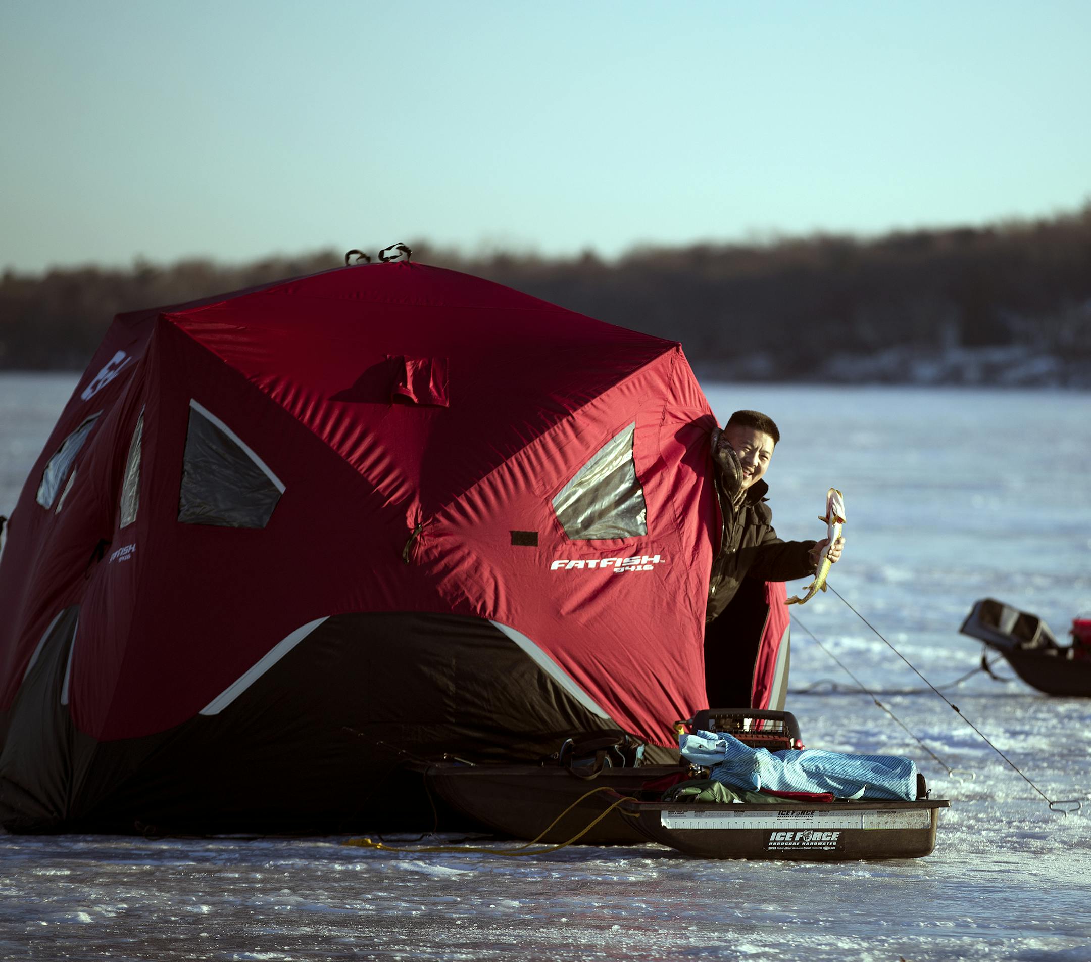 Tay Xiong held a small northern pike after catching it while ice fishing on White Bear Lake Wednesday December 28,2016 in White Bear, MN.] Jerry Holt / jerry. Holt@Startribune.com