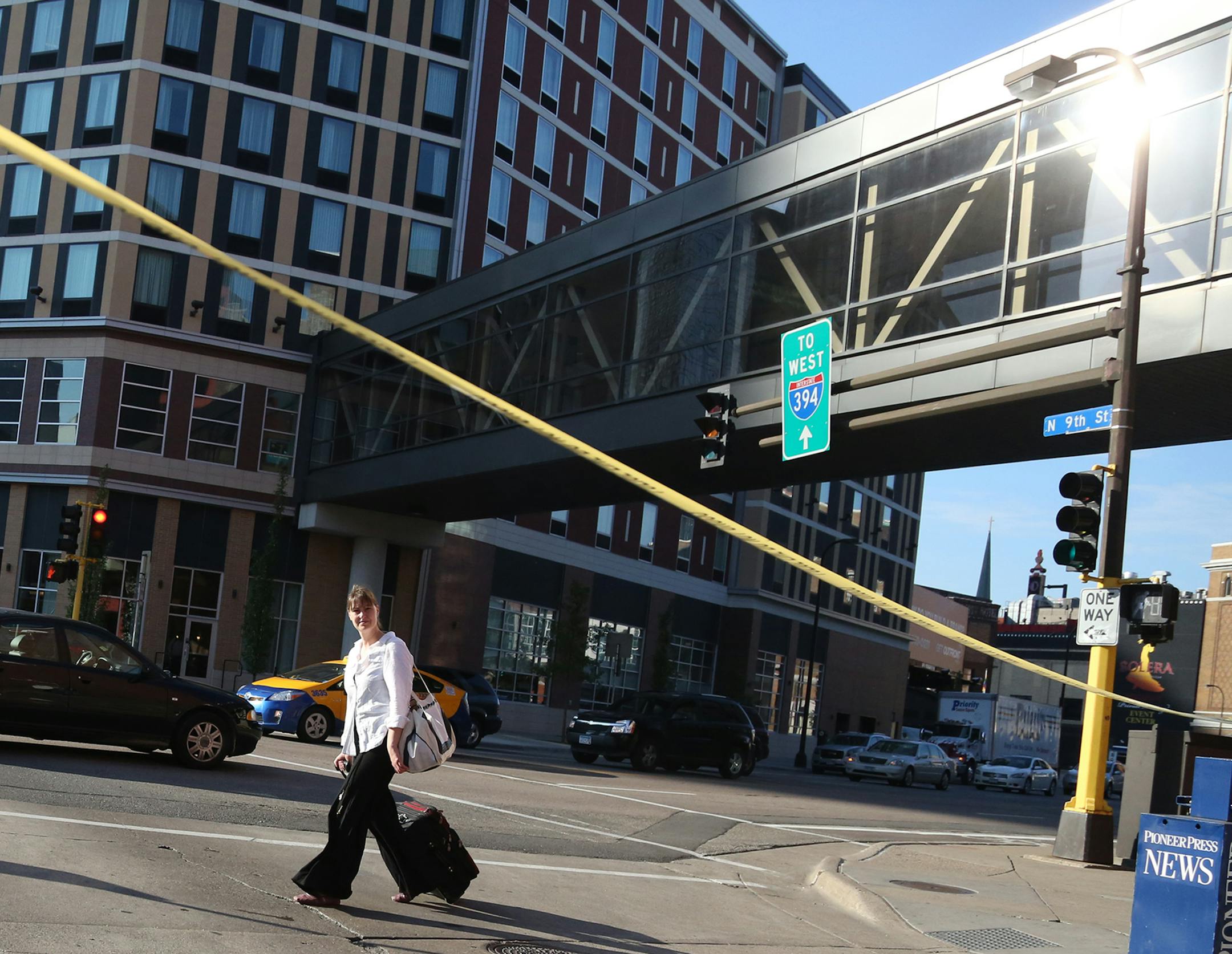 A pedestrian walked by the crime tape where a woman was stabbed by another in the transit station in Ramp A. ] (KYNDELL HARKNESS/STAR TRIBUNE) kyndell.harkness@startribune.com A fatal stabbing between two women at the Ramp A transit station in Minneapolis, Min., Thursday, June 25, 2015.