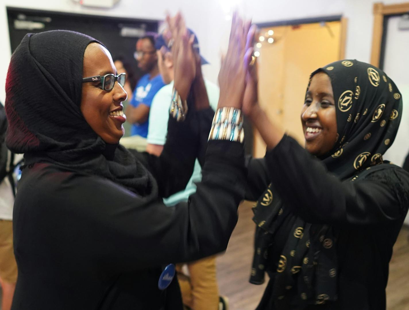 Degha Shabbeleh (left) and Maymuna Sahal celebrate incoming results. ] MARK VANCLEAVE &#x2022; mark.vancleave@startribune.com * Supporters of congressional district five candidate Ilhan Omar gathered at Safari Restaurant in south Minneapolis.