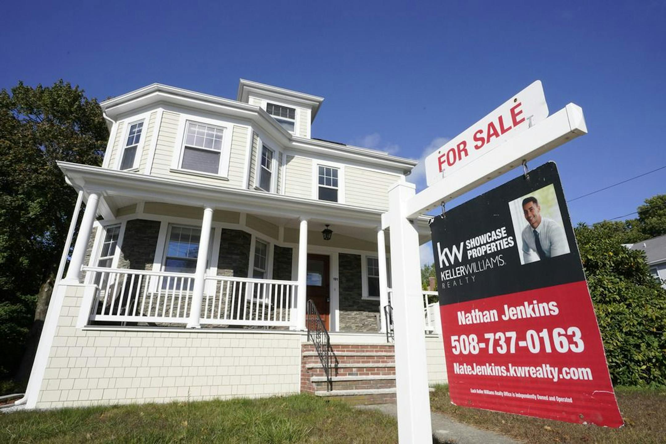 A for sale sign stands in front of a house, Tuesday, Oct. 6, 2020, in Westwood, Mass. Even with mortgage rates hovering near all-time lows, rising home prices are putting more pressure on buyers to come up with a bigger down payment. The trend is stretching the limits of affordability for many Americans already struggling to save for a down payment as incomes fail to keep pace with home values.
