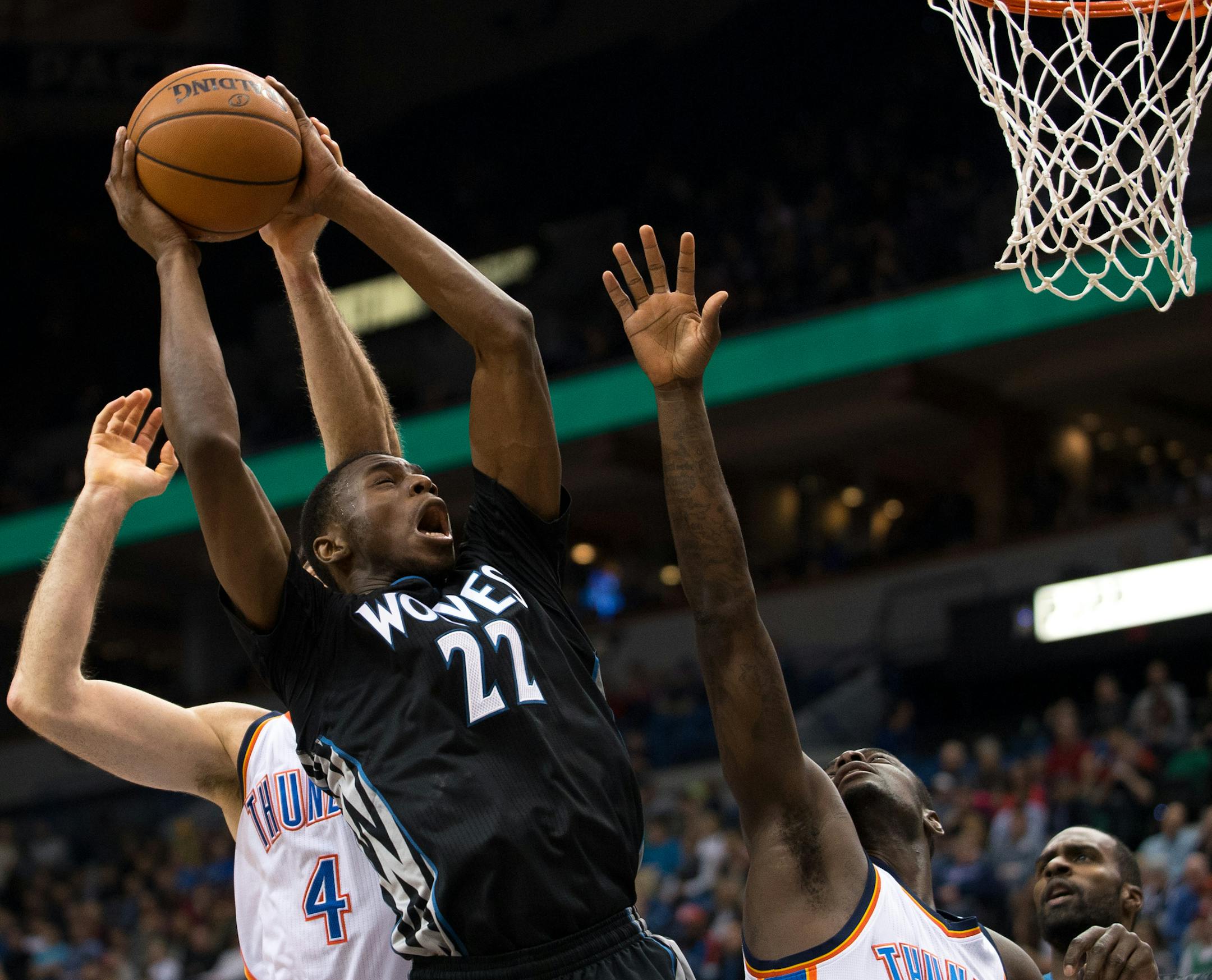 Minnesota Timberwolves forward Andrew Wiggins (22) can't score while being defended by Oklahoma City Thunder forward Nick Collison (4) and guard Anthony Morrow (2) during the first quarter. ] AARON LAVINSKY • aaron.lavinsky@startribune.com The Minnesota Timberwolves take on the Oklahoma City Thunder Friday, Dec. 12, 2014 at Target Center in Minneapolis, Minn.