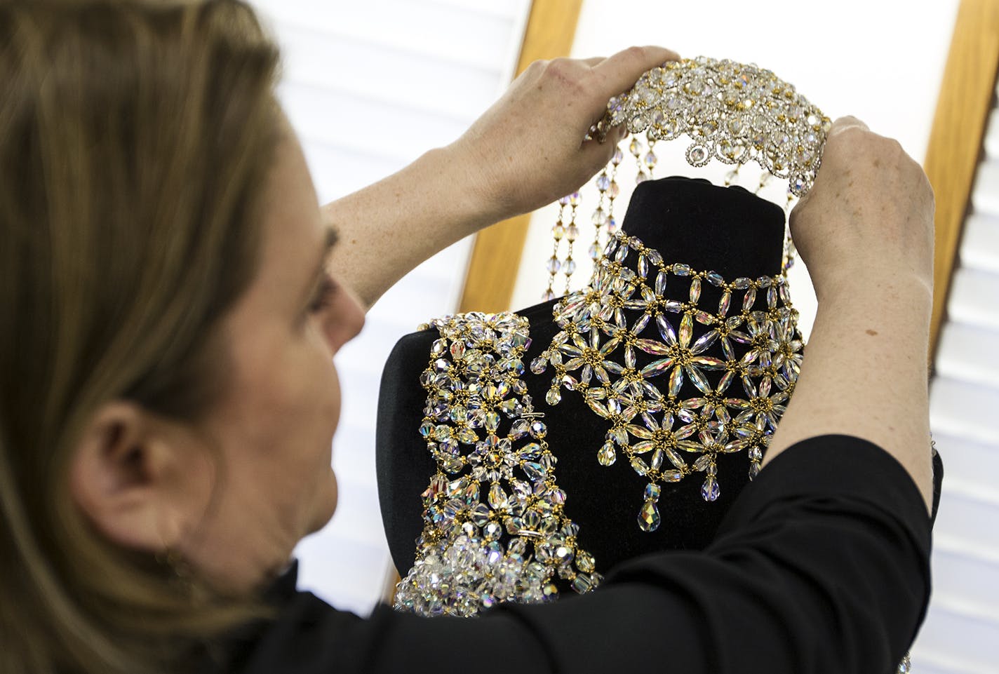 Beadworker Gail Be lifts up a head piece she created that was worn by Lady GaGa and appears on GaGa's latest album, Cheek to Cheek, with Tony Bennett at Gail Be Designs in Edina October 13, 2014. (Courtney Perry/Special to the Star Tribune)