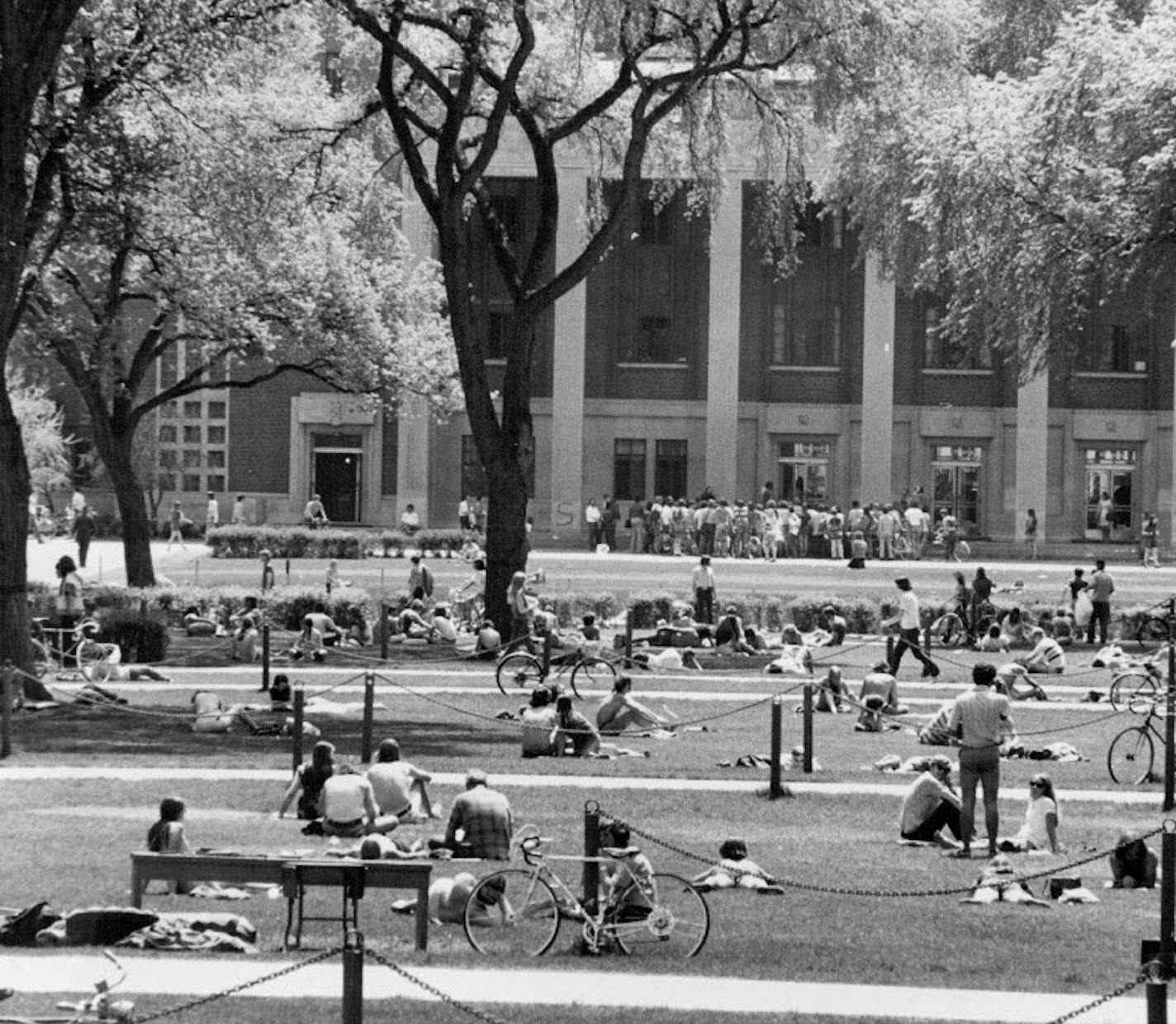 Students sat on Northrop Mall in May, 1972, as a small antiwar protest took place in front of Corrman Union (rear of photo). The Mall's original plan called for a sloping parkland going down to the river, but Coffman cut that off.