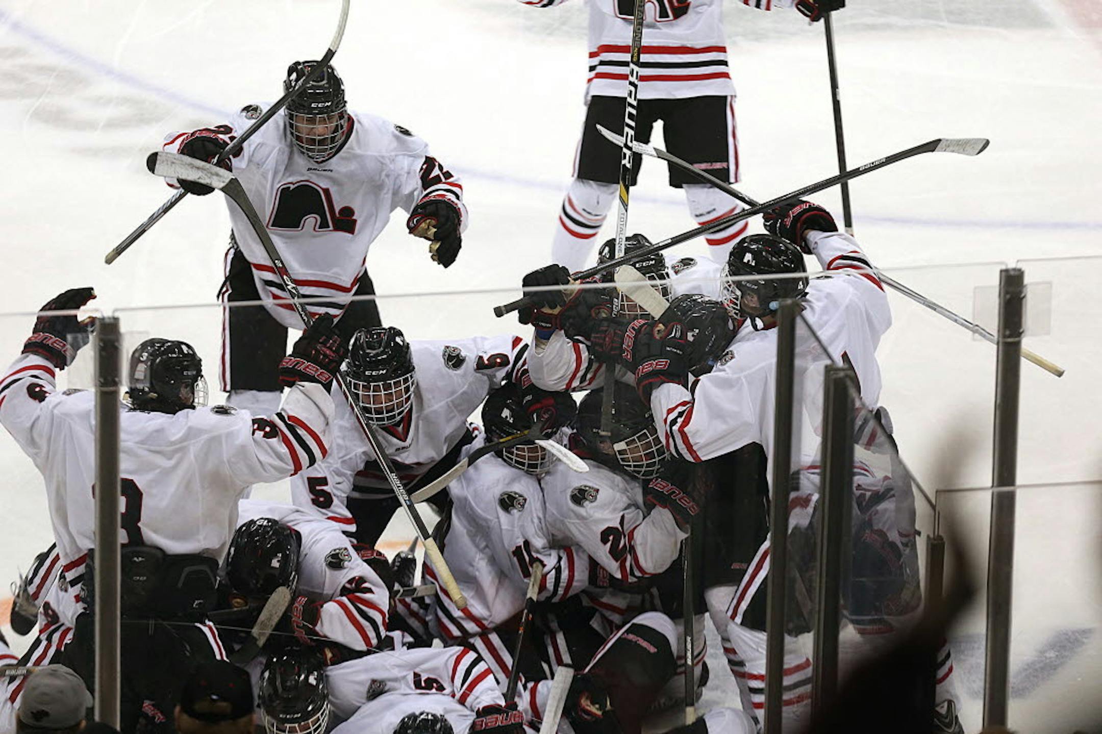 Lakeville North players celebrated their dramatic, 5-4 victory in double overtime on a goal by Nick Poehling in the Class 2A semifinal Friday night at Xcel Energy Center in St. Paul.