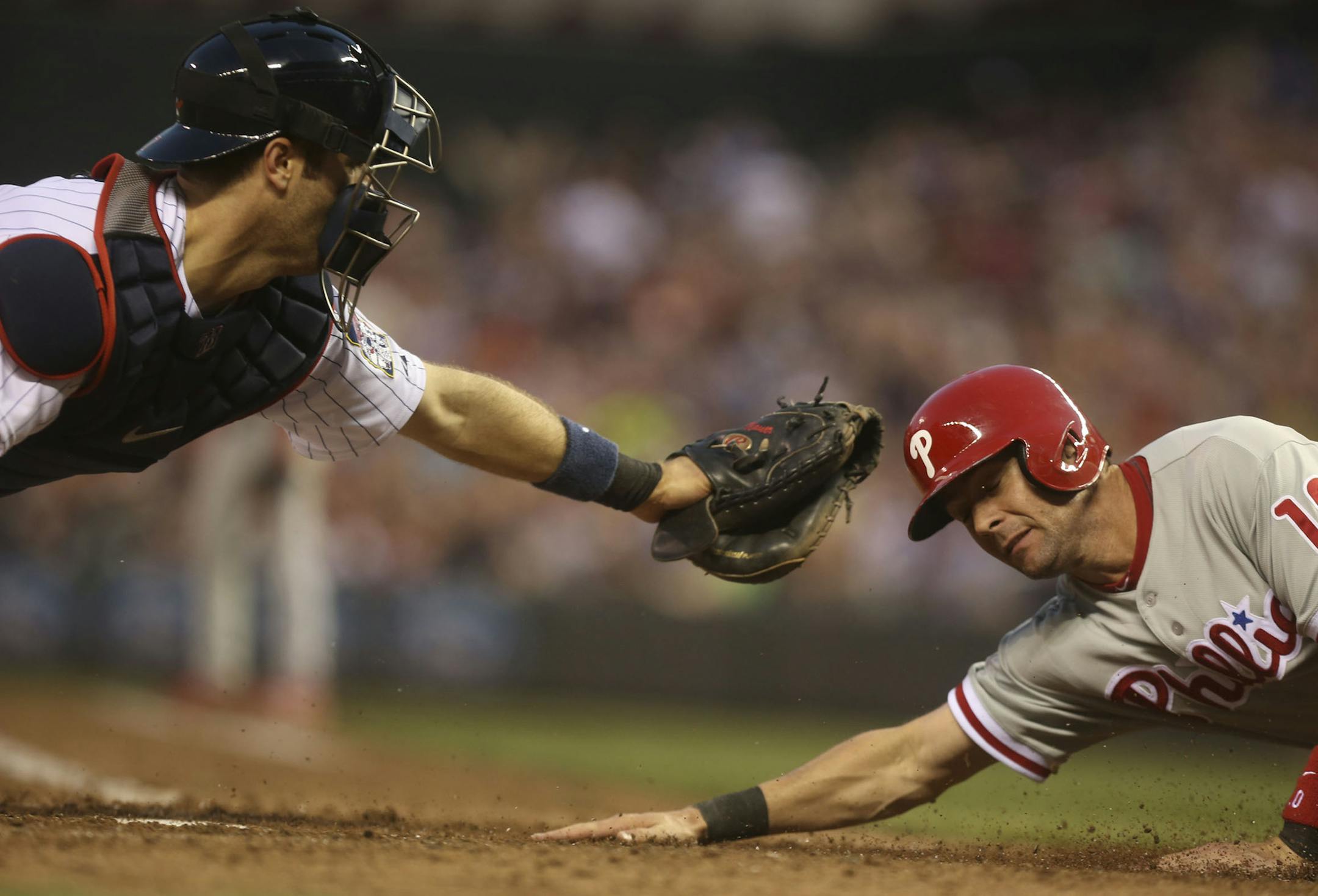 Twins Joe Mauer tagged out Phillies Michael Young at home plate in the sixth inning at Target Field in Minneapolis, Min., Thursday, June 13, 2013. ] (KYNDELL HARKNESS/STAR TRIBUNE) kyndell.harkness@startribune.com
