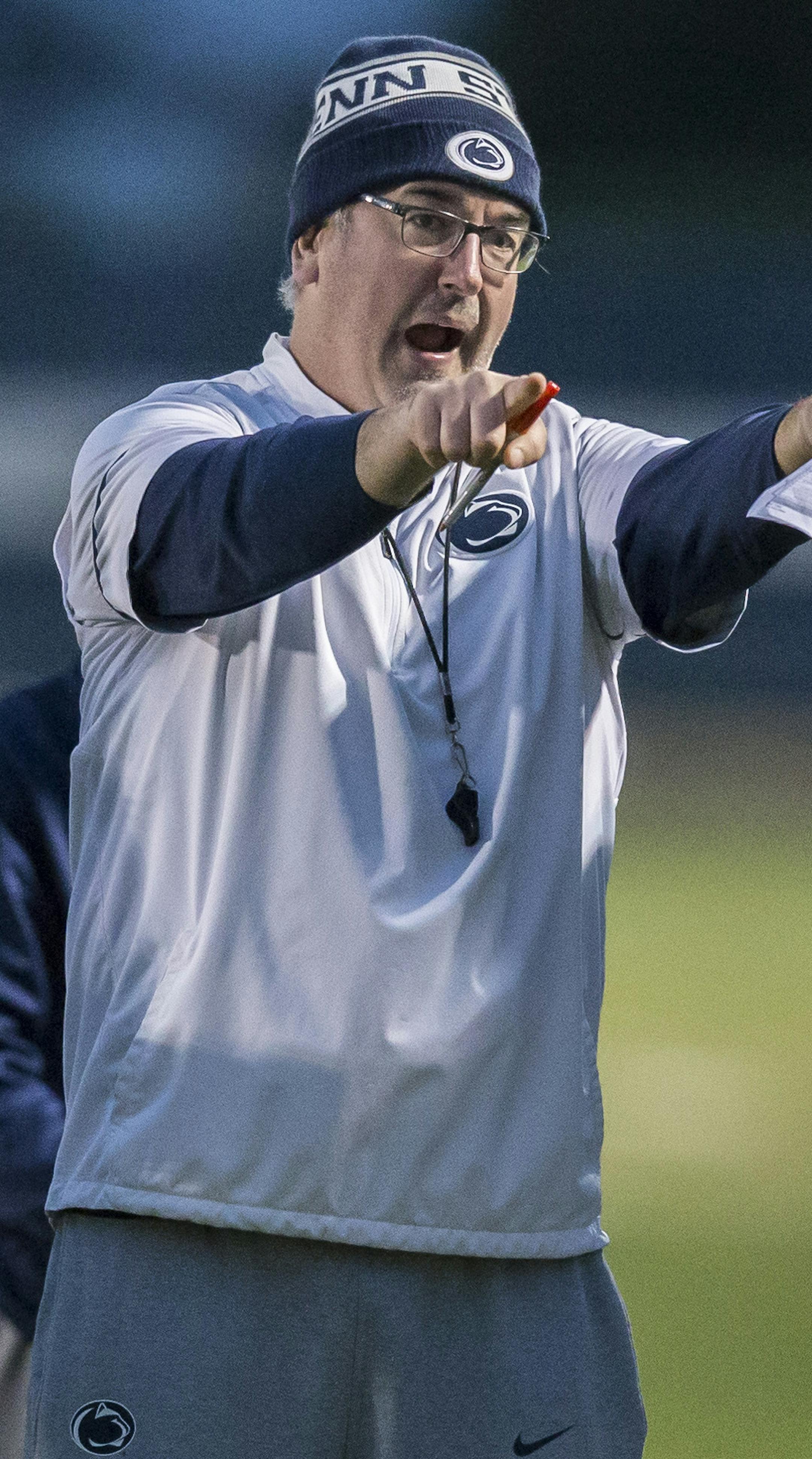 Penn State head coach James Franklin, left, looks on as offensive coordinator Joe Moorhead talks with quarterback Tommy Stevensduring football practice, Wednesday, Oct. 25, 2017 in State College, Pa. (Joe Hermitt/PennLive.com via AP)