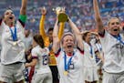 Megan Rapinoe of the USA celebrates with the FIFA Women's World Cup Trophy following her team's victory in the 2019 FIFA Women's World Cup France Fina