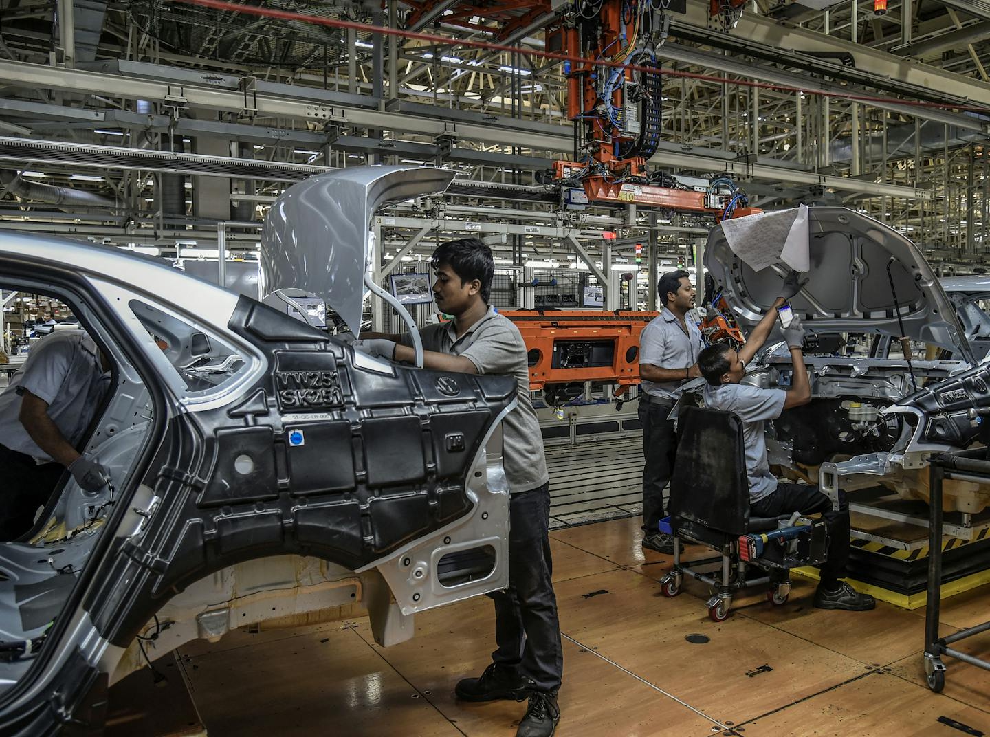 FILE -- Workers at a car manufacturing plant in Chakan, near Pune, India, an industrial hub, April 17, 2019. The Trump administration is on the cusp of announcing a new trade deal with India, potentially within the next week as President Donald Trump prepares to meet with Prime Minister Narendra Modi of India. (Atul Loke/The New York Times)