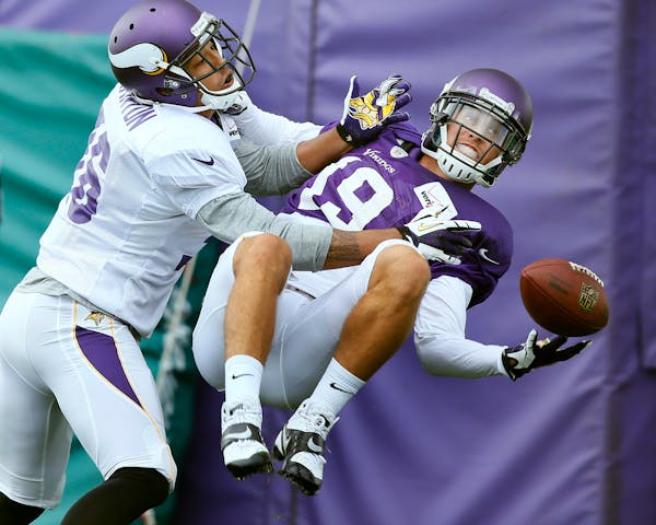 Robert Blanton,left, keep Adam Thielen from catching the ball during NFL camp at Minnesota State University, Mankato in July, 2014.