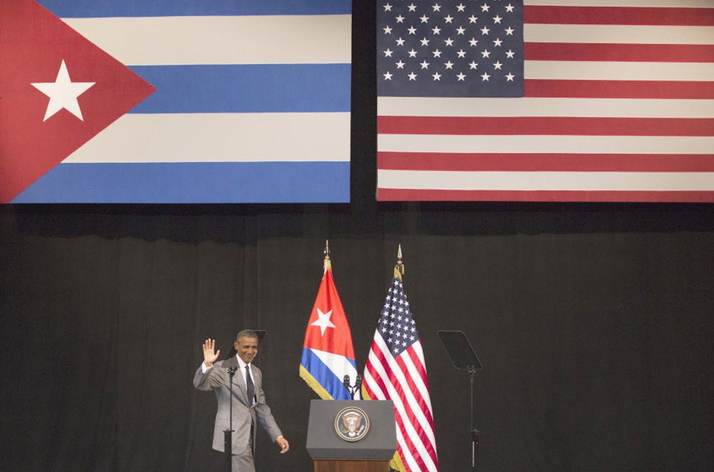 United States President Barack Obama waves as he arrives to the podium to address the Cuban people at the National Theater in Havana, Cuba, Tuesday, March 22, 2016. Havana's National Theater are almost completely empty of ordinary Cubans shortly before Obama's main speech of his history-making visit to Cuba. He was briefed Tuesday morning on the Brussels attacks that killed dozens of people.(AP Photo/Desmond Boylan)