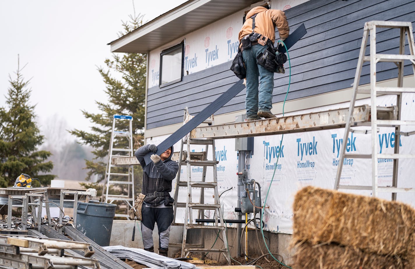 Workers at a Cardinal Homes construction site in Woodbury in March.