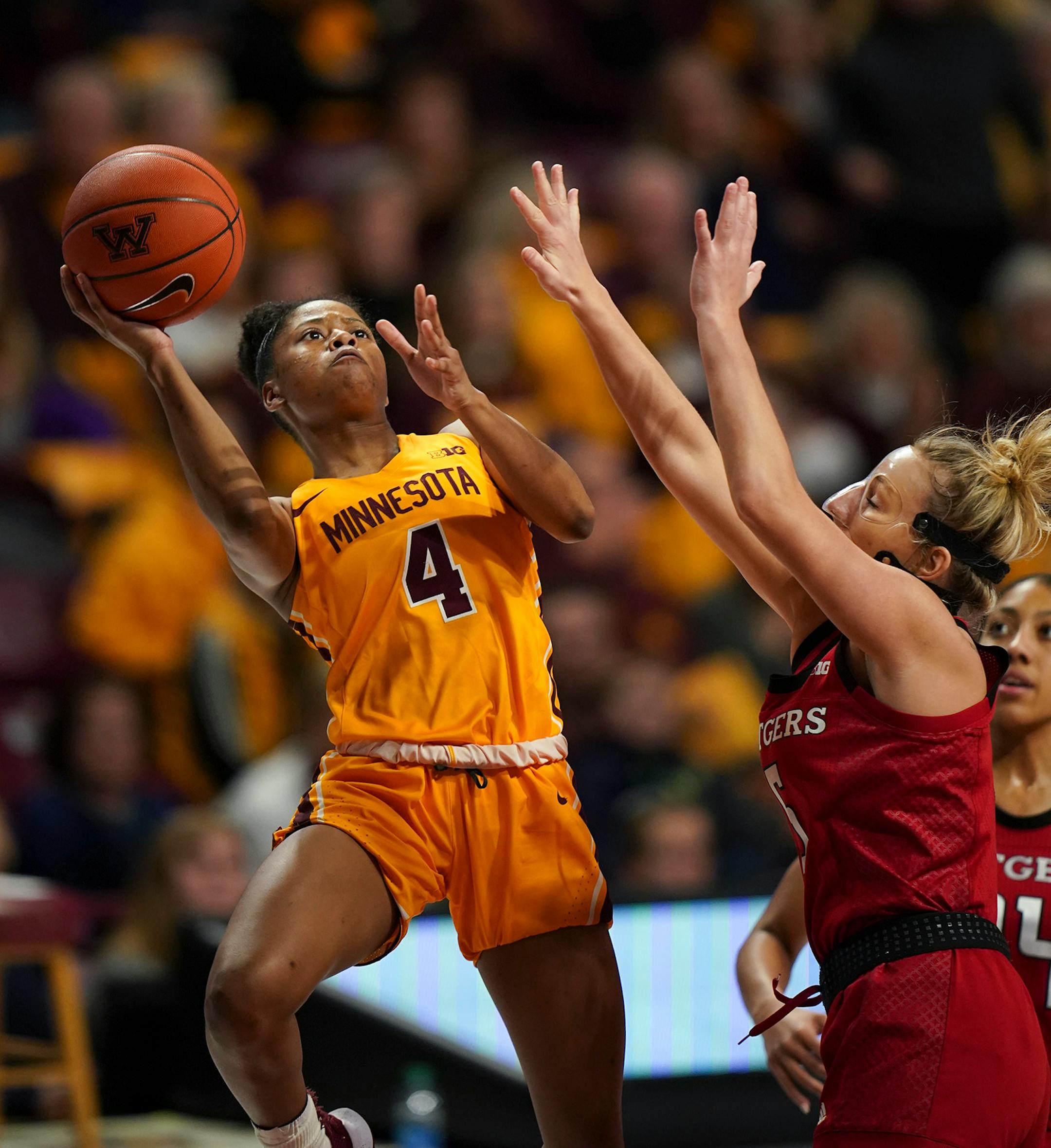 Minnesota Gophers guard Jasmine Powell (4) shot around Rutgers Scarlet Knights guard Danielle Migliore (5) in the third quarter.
