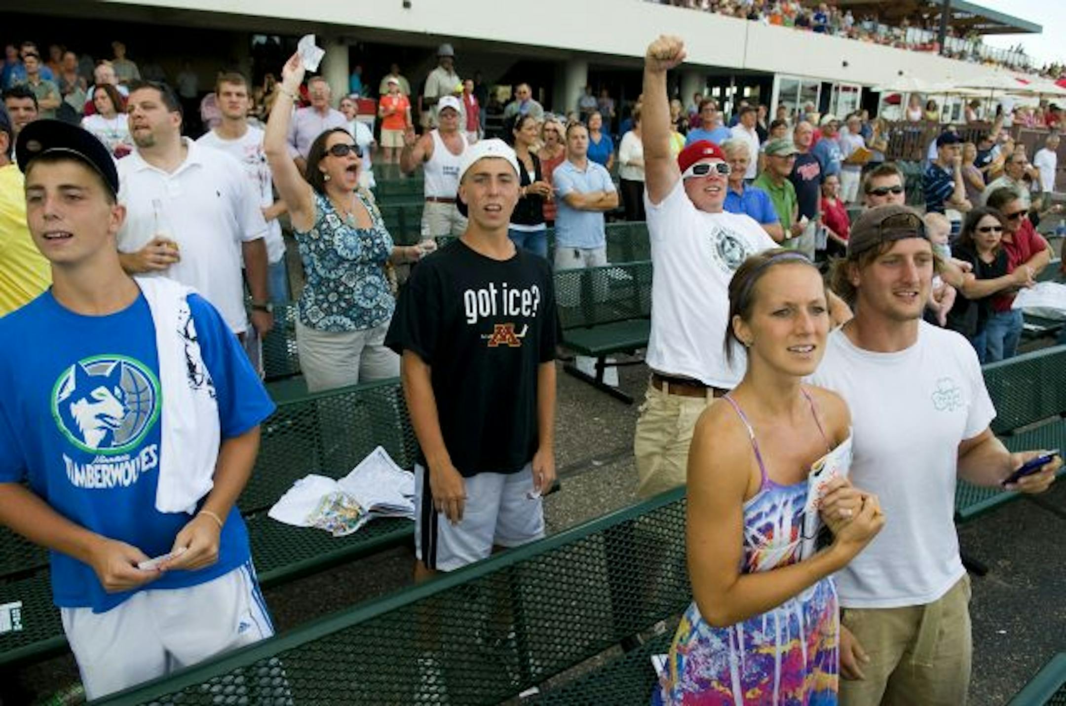 A crowed of 11,473 cheer on the horses as they come around the last straight away during the ninth race of the day at the Claiming Crown at Canterbury Park on Saturday in Shakopee.