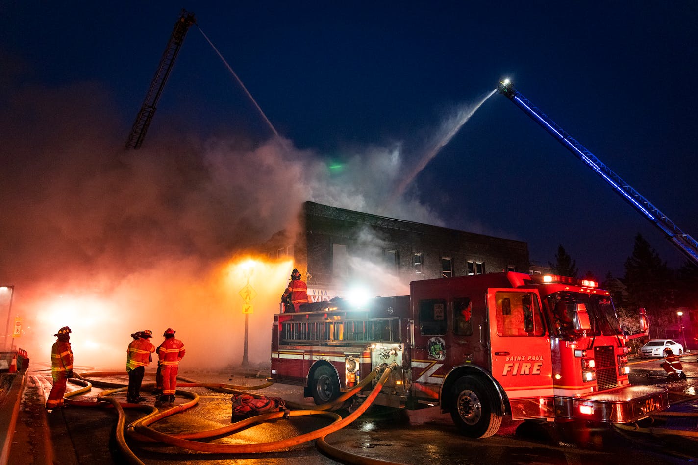 St. Paul Fire Department crews battle a fire that severely damaged a building housing a video store and apartments on University Avenue in St. Paul. in St. Paul, Minn. Wednesday, Jan. 10, 2024. ] LEILA NAVIDI • leila.navidi@startribune.com