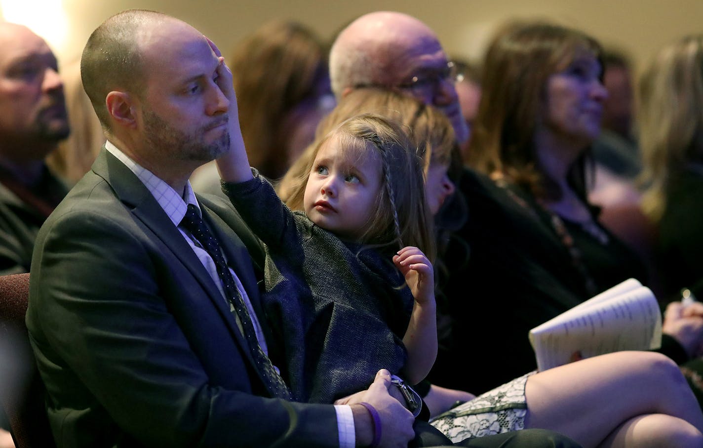 Brian Muller received comfort from his daughter EmmyLu as he bid farewell to his wife Amie Dahl Muller, 36, during her funeral services at Crossroads Church, Friday, February 24, 2017 in Woodbury, MN. Air Force veteran Amie Muller believed deployments to Iraq caused the pancreatic cancer that killed her last weekend. She worked and lived next to burn pits in Balad Air Base that billowed toxic smoke night and day. ] ELIZABETH FLORES &#x2022; liz.flores@startribune.com