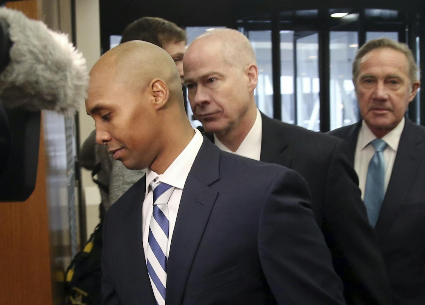 Mohamed Noor, left, the former Minneapolis police officer, arrives at the Hennepin County Government Center Friday, March 1, 2019 in Minneapolis for a hearing.