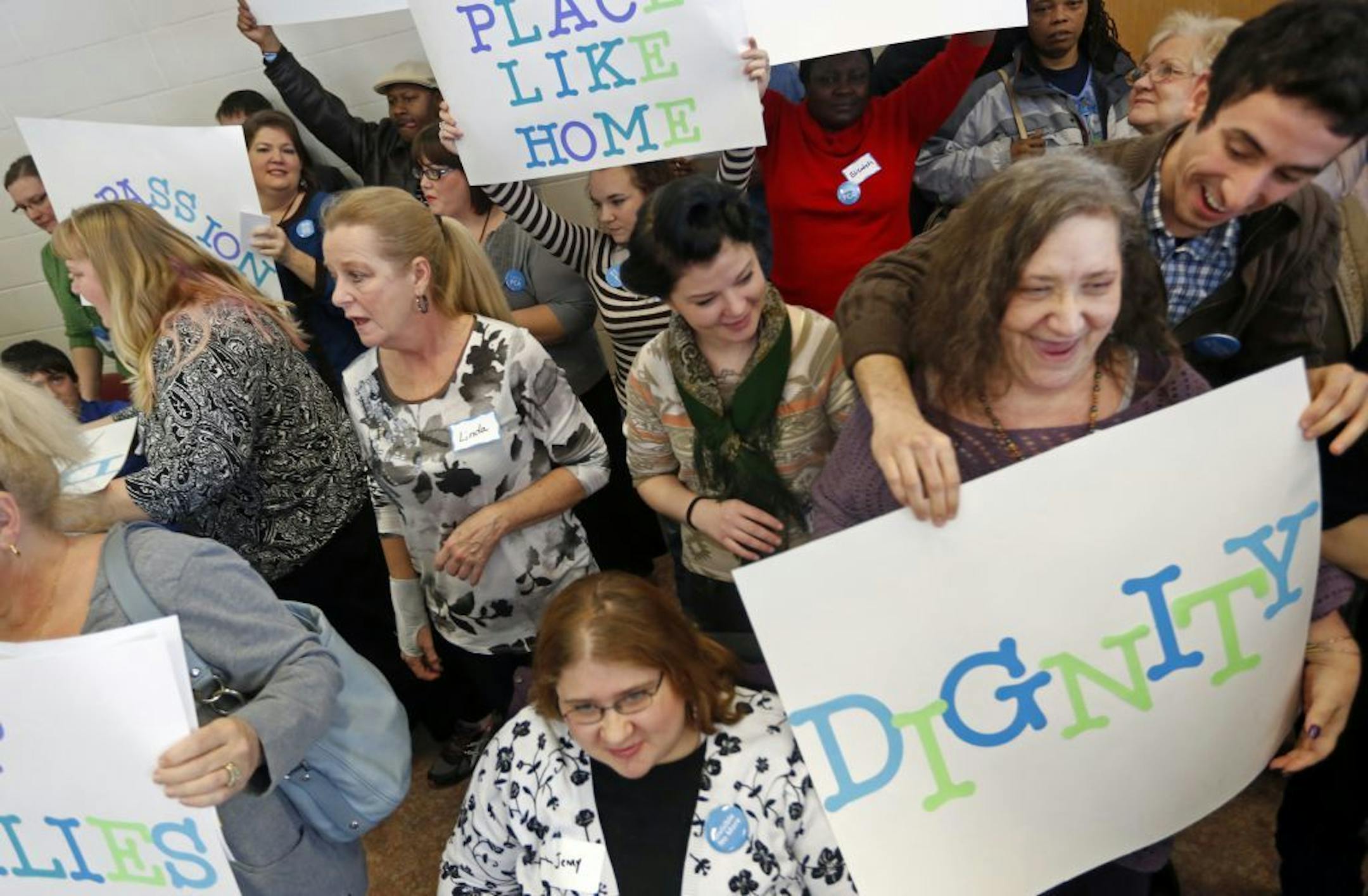 At the Dunning Recreation Center in St. Paul, personal care attendants and their suppporters want PCA's to organize through the SEIU, the service employees' union. On the far right is Lynn Rubenstein Nicholson who has a degenerative spinal disease and has her son as a PCA, and PCA friend Orlando Sanchez.