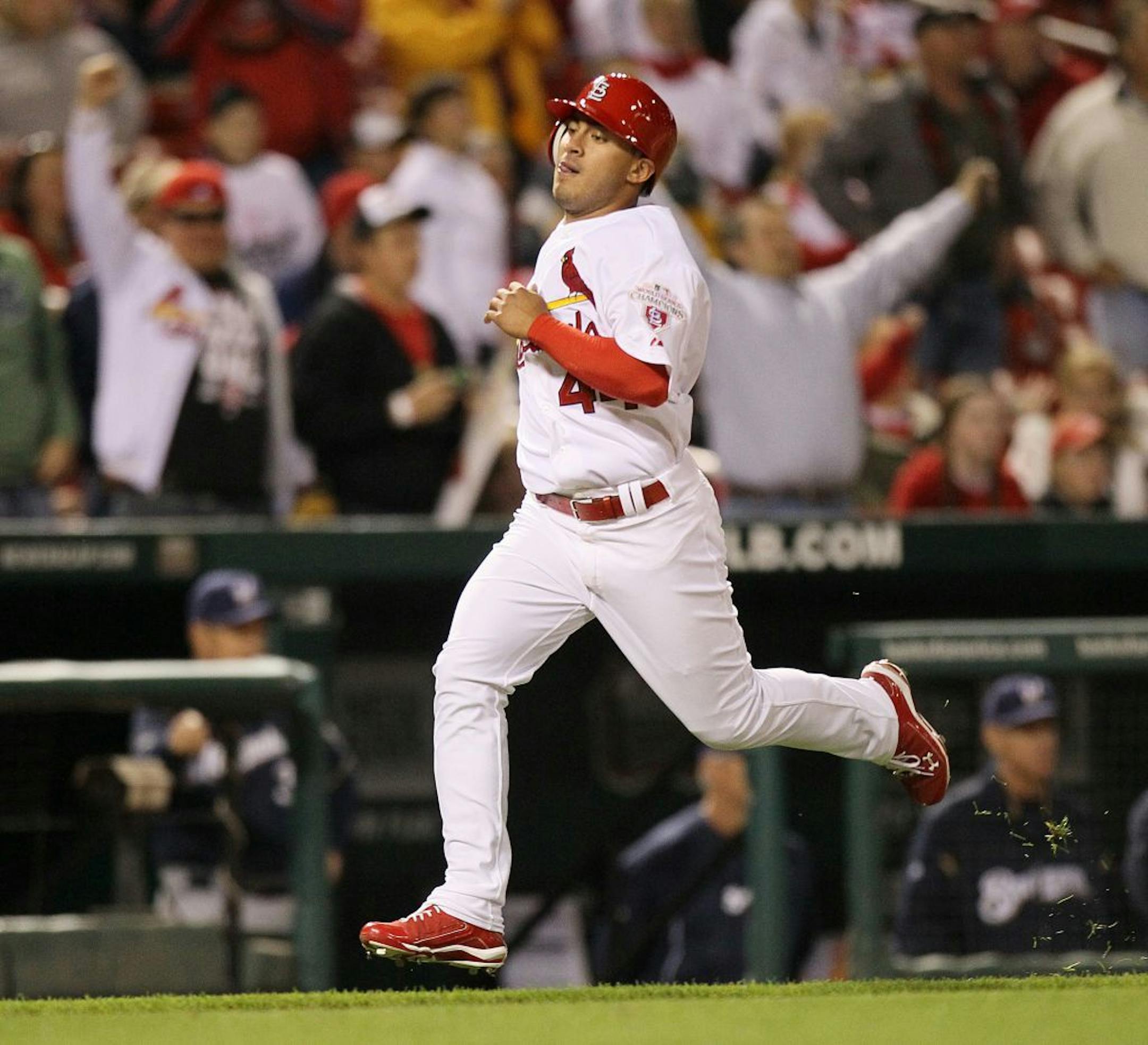 The St. Louis Cardinals' Erik Komatsu scores the final run of a 13-1 victory, on a single by Yadier Molina in the eighth inning, against the Milwaukee Brewers on Friday, April 27, 2012, at Busch Stadium in St. Louis, Missouri.