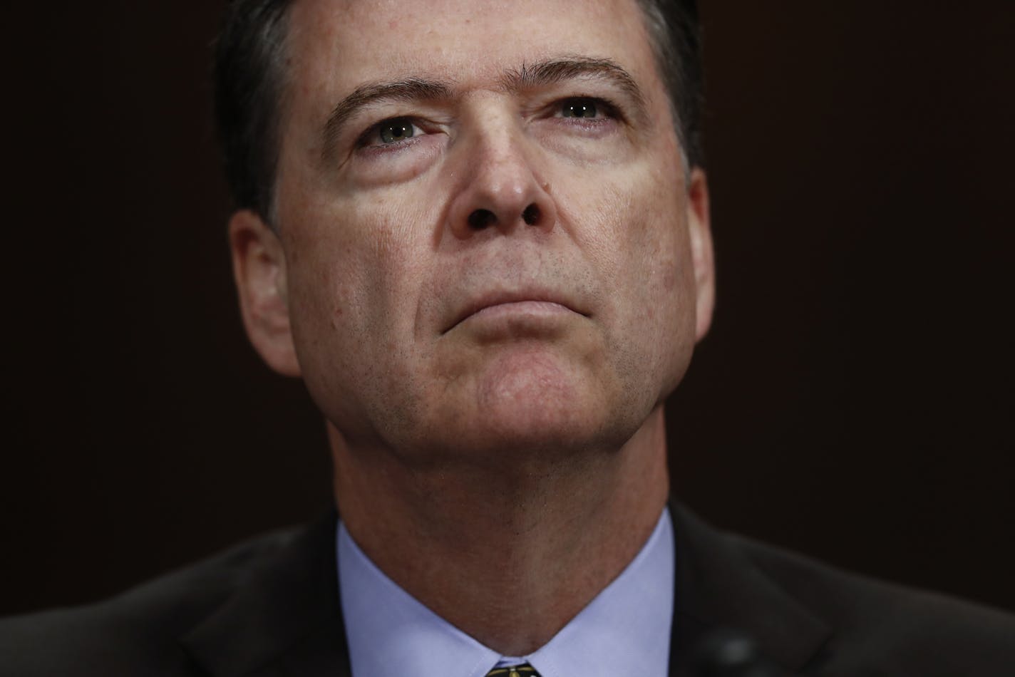 In this Wednesday, May 3, 2017, photo, then-FBI Director James Comey pauses as he testifies on Capitol Hill in Washington, before a Senate Judiciary Committee hearing. President Donald Trump abruptly fired Comey on May 9, ousting the nation's top law enforcement official in the midst of an investigation into whether Trump's campaign had ties to Russia's election meddling.(AP Photo/Carolyn Kaster)