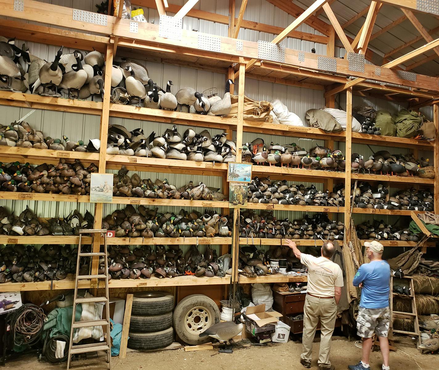 Bill Gombold, left, looked over his decoy collection in his pole barn.