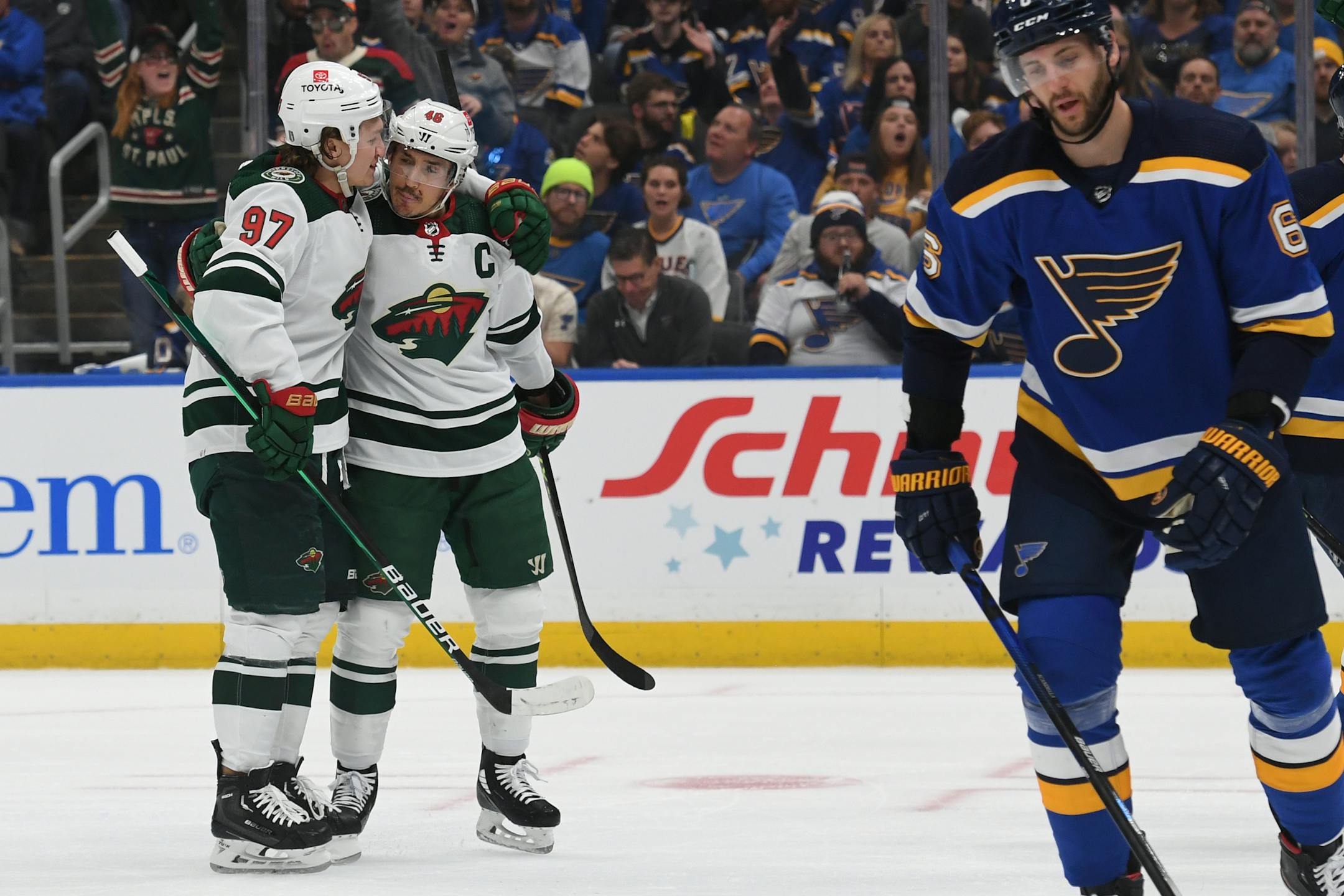 Minnesota Wild's Kirill Kaprizov (97) and Jared Spurgeon (46) celebrate after scoring a goal during the first period in Game 4 of an NHL hockey Stanley Cup first-round playoff series on Sunday, May 8, 2022, in St. Louis. (AP Photo/Michael Thomas)