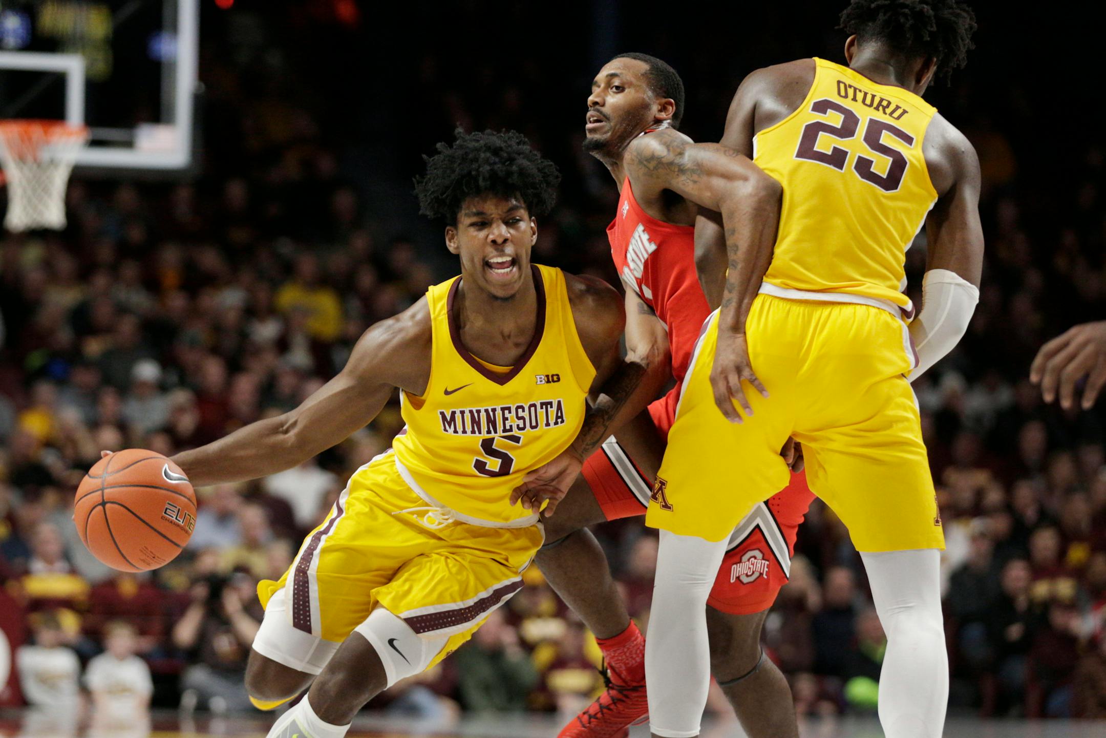 Gophers guard Marcus Carr drives around a pick by center Daniel Oturu as Ohio State guard Luther Muhammad defended.
