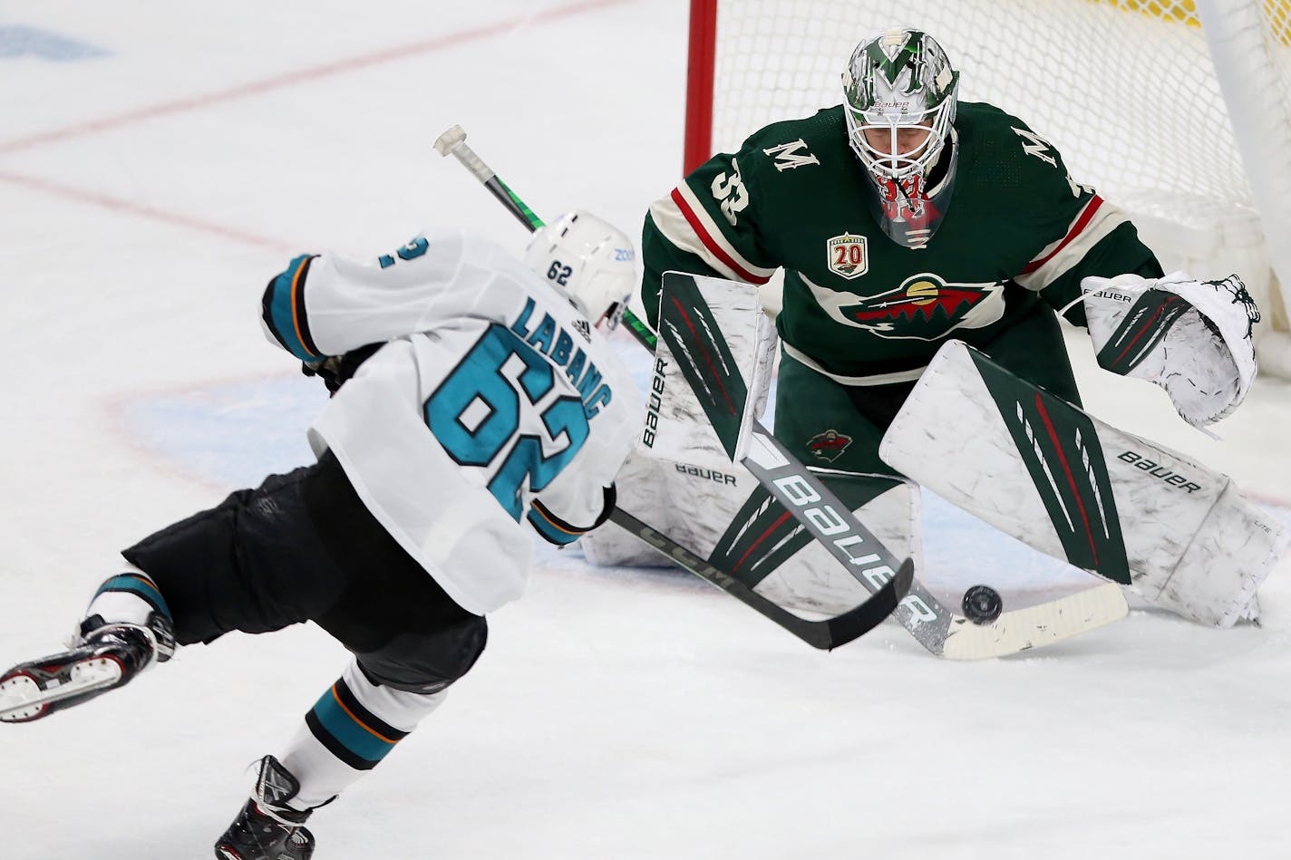 Minnesota Wild's goalie Cam Talbot (33) stops the puck shot by San Jose's Kevin Labanc (62) during the third period of an NHL hockey game Friday, April 16, 2021, in St. Paul, Minn. (AP Photo/Stacy Bengs)