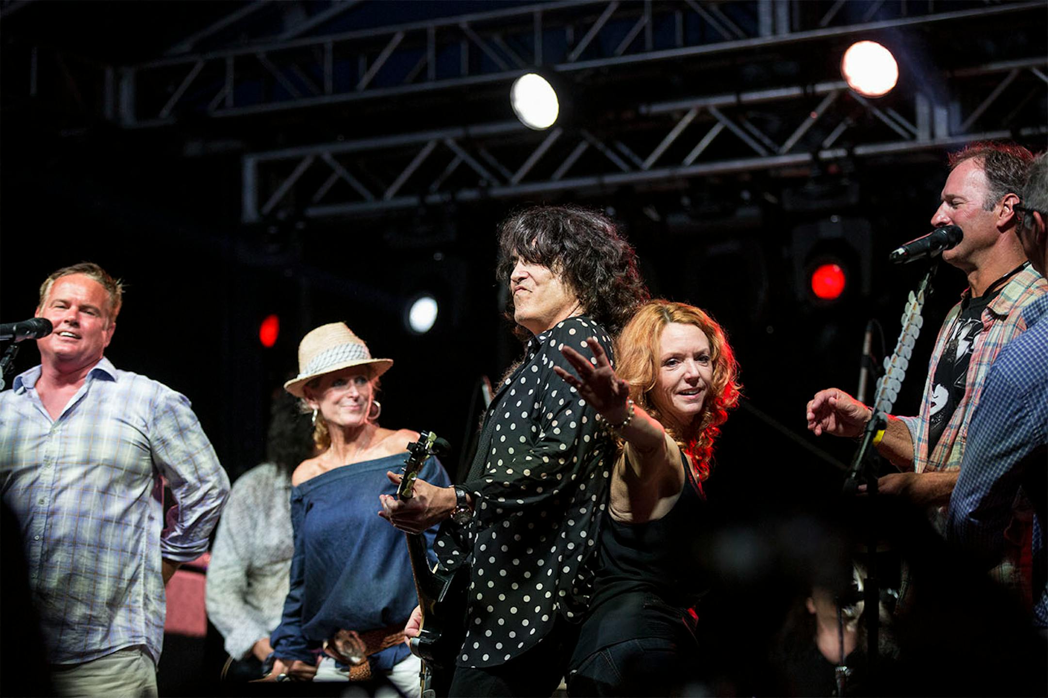 Members of the crowd came on stage with Kiss (Paul Stanley in this picture) as they performed their final song "I'm wanna to Rock N Roll all night" during a charity concert at philanthropist Martha "Muffy" MacMillan's home on Tuesday, August 2, 2016, in Long Lake, Minn.