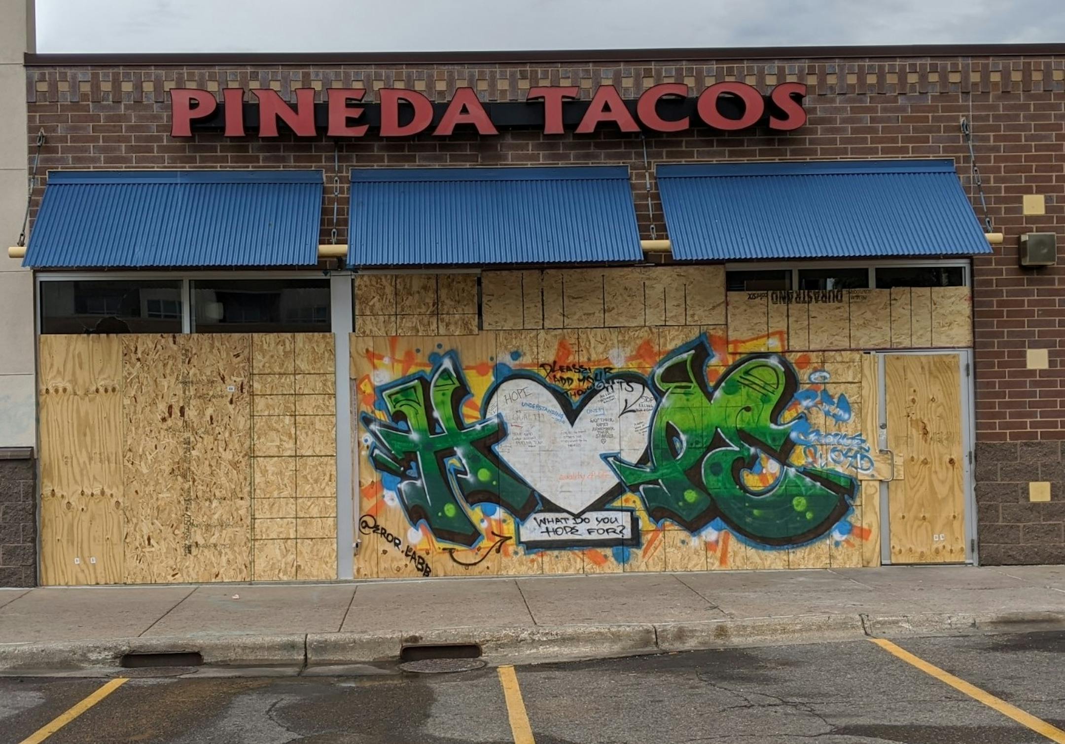A mural on the front of Pineda Tacos (2130 E Lake St., Minneapolis) invites passersby to write what they hope for inside a white heart.