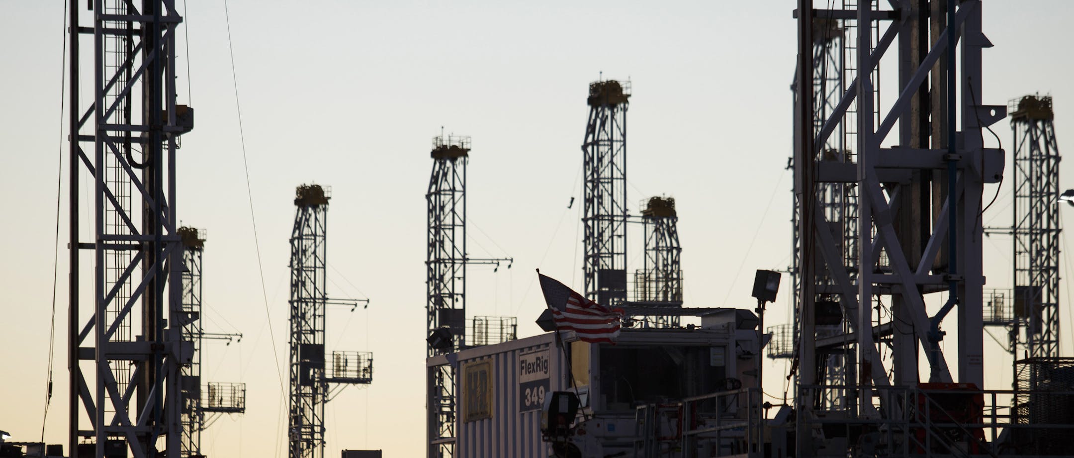 Oil rigs stacked for storage near Midland, Texas, Jan. 27, 2016. There are now virtually no wells in the United States profitable to drill. That has forced some companies into a fatal spiral, producing oil simply to satiate their lenders. (Michael Stravato/The New York Times)